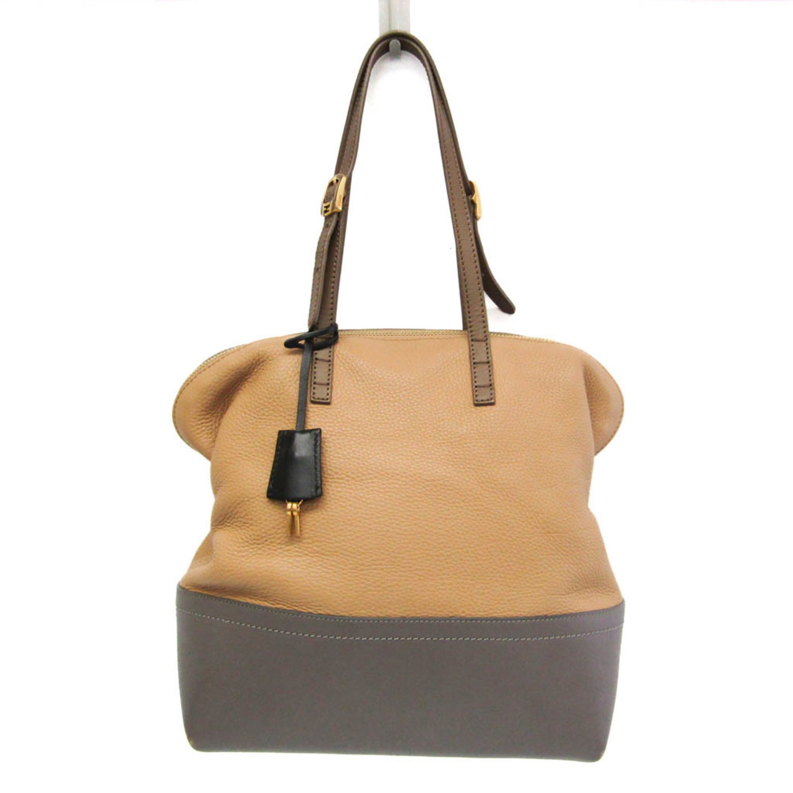 Fendi Tote Bag Leather: Fendi Tote Bag Leather Fendi Tote Bag Leather is a high-quality, Italian-made tote bag featuring a sturdy grayish, light brown leather exterior with a zipper closure. The bag boasts two functional poc