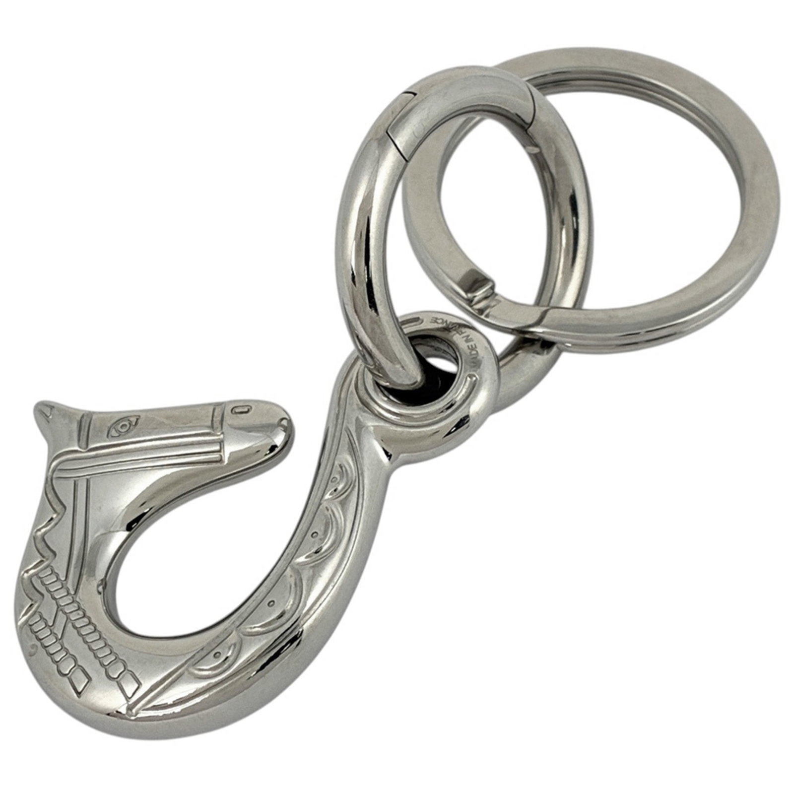Keyring Metal Hermes: Keyring Metal Hermes Silver metal keyring with the iconic Hermes brand. This stylish accessory features a sleek metal design that adds a touch of sophistication to any keychain. Item Specifics: Brand: