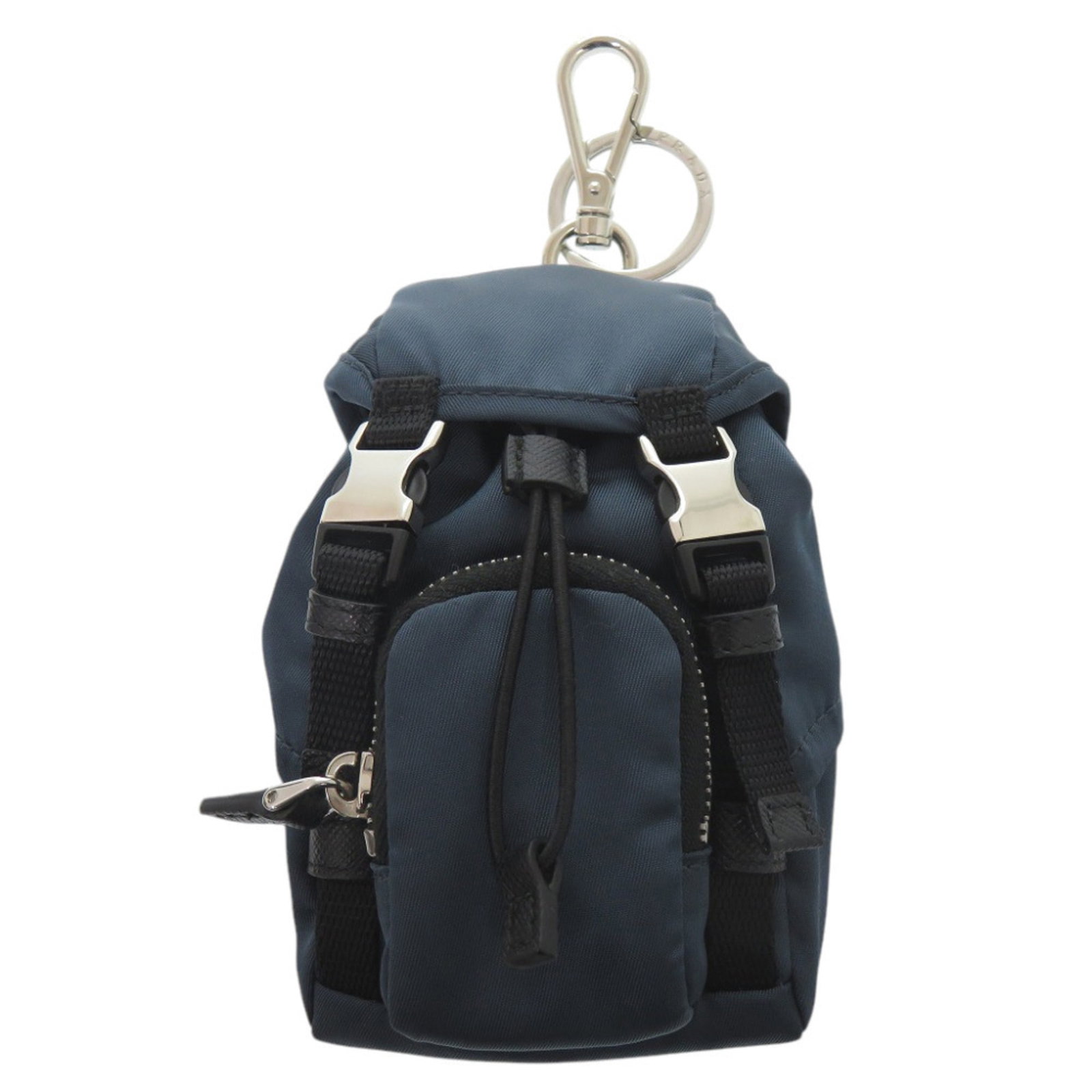 Keyring Nylon Prada: Keyring Nylon Prada Nylon keyring from Prada, available in navy and silver, with a size of 13cm x 8cm x 7cm. Made from durable nylon, this keyring is a functional accessory. The Prada brand is known f