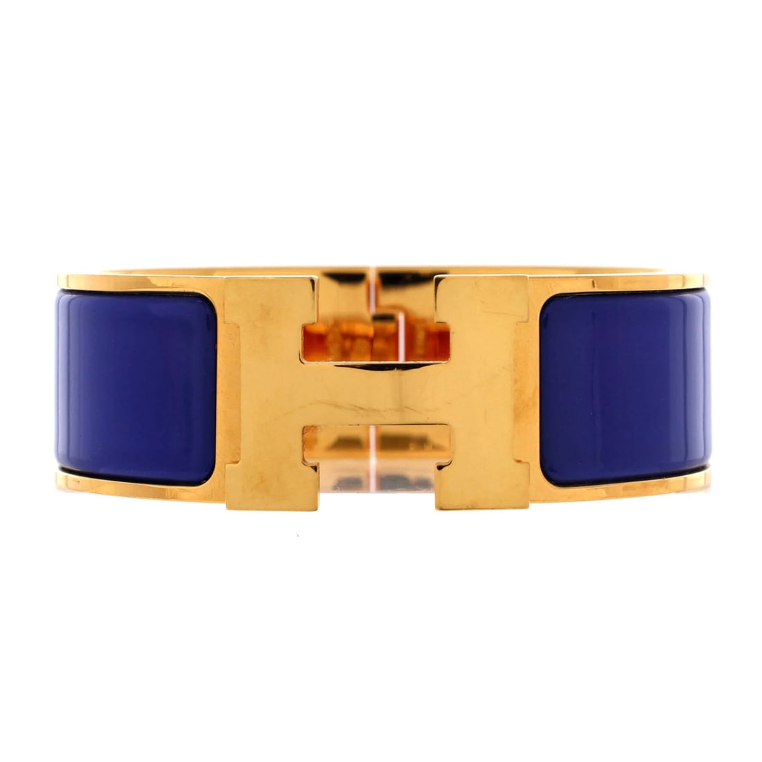Enamel Wide Clic Hermes Bracelet: Enamel Wide Clic Hermes Bracelet Blue enamel and gold details adorn this 6.5" wide Clic H bracelet, a classic Hermes style with a wide exterior. The item bears a signature, a notable feature of this