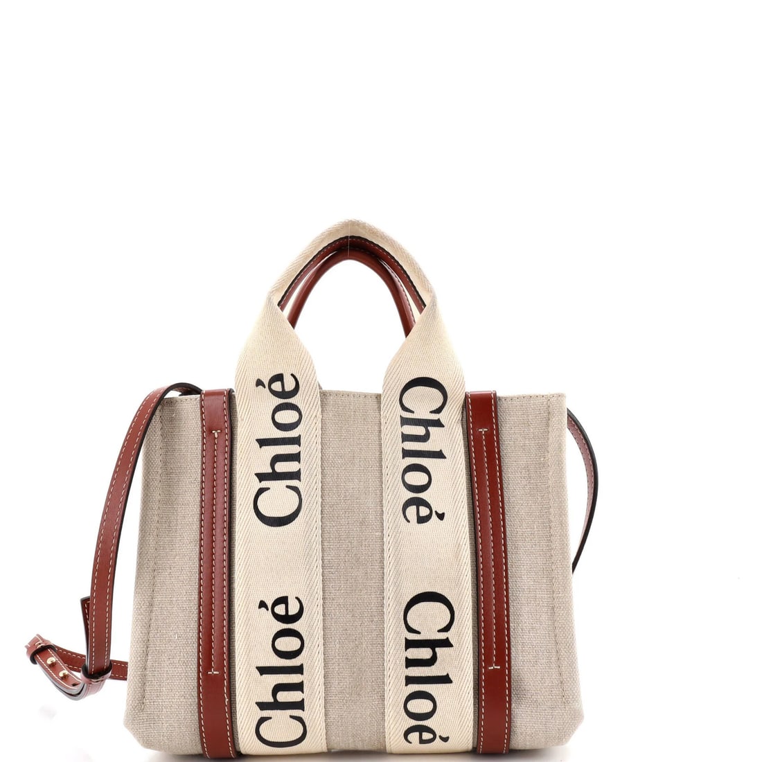 Woody Canvas Tote Small Leather Chloe: Woody Canvas Tote Small Leather Chloe Small Leather Chloe Woody Canvas Tote in Neutral Brown. This stylish tote features a canvas exterior with a small leather trim and gold hardware, measuring 10.5" 