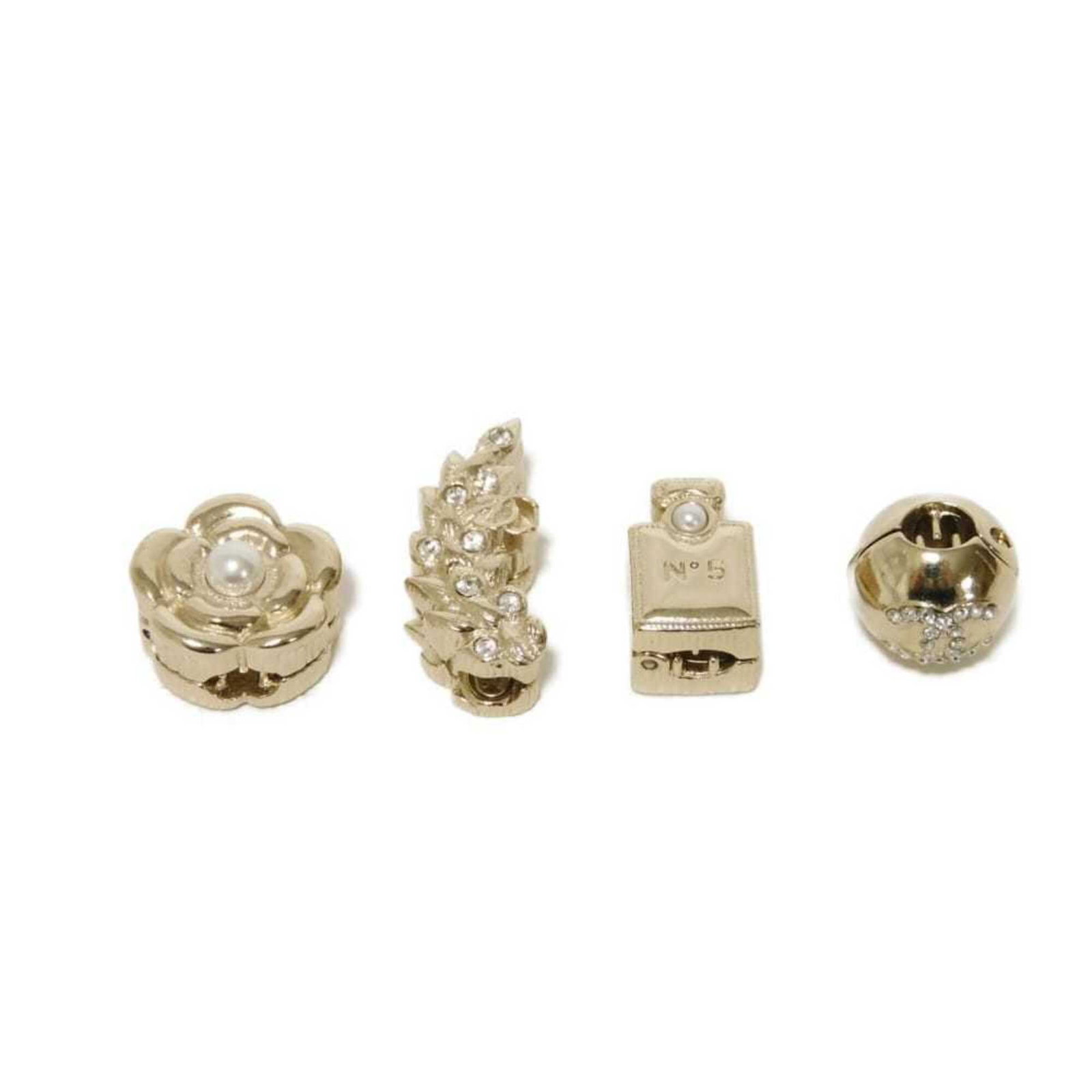 Hair Clip by Chanel: Hair Clip by Chanel Champagne gold and white hair clip by renowned luxury brand Chanel, measuring 2cm x 1.3cm. This elegant hair accessory boasts a sleek design and premium materials, adding a touch