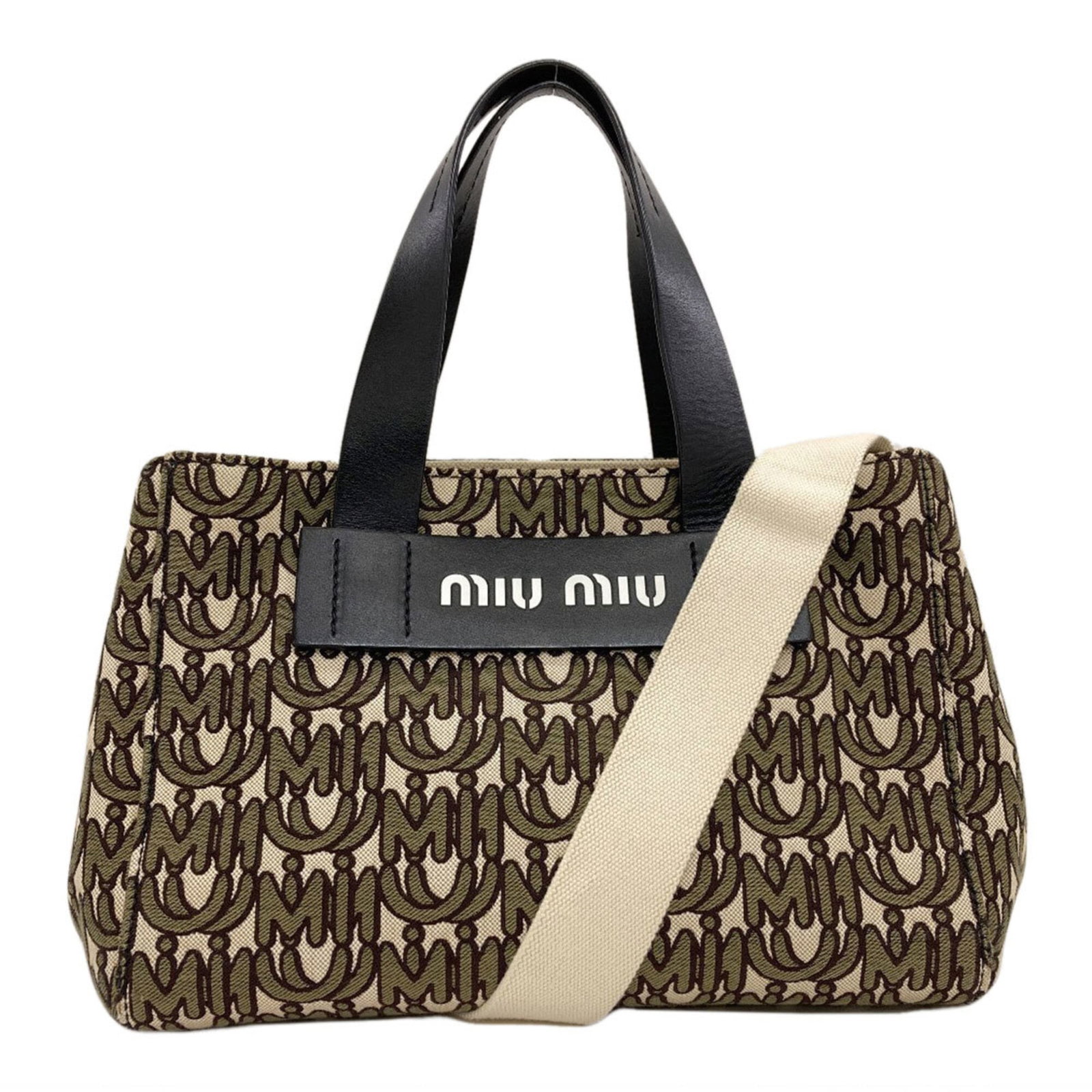 Canvas Miu Handbag: Canvas Miu Handbag Canvas Miu Handbag - A stylish and versatile accessory, this khaki canvas handbag features a classic design with clean lines and a spacious interior. Measuring 20cm x 29cm x 14cm,