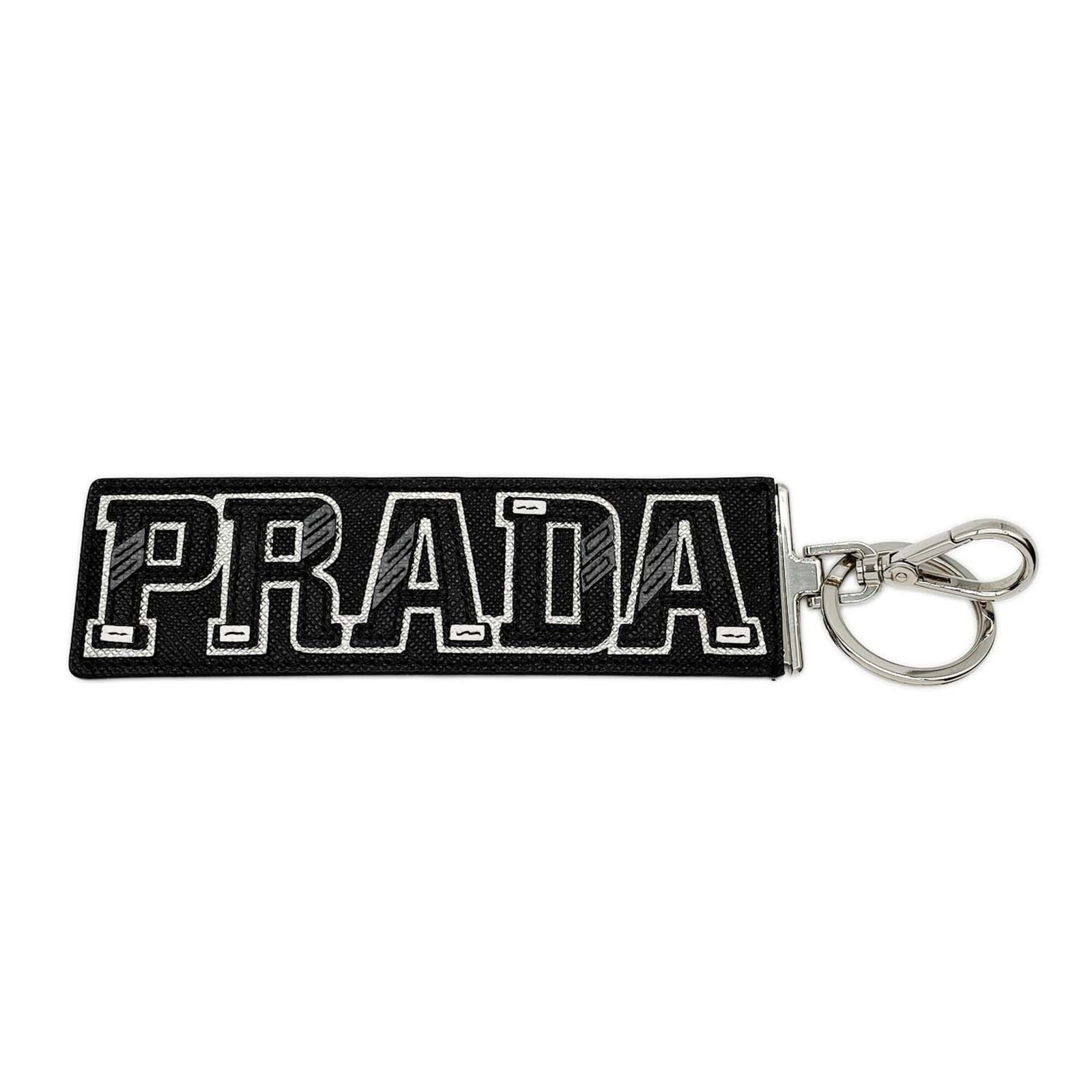 Keyring Leather By Prada: Keyring Leather By Prada Prada's sleek keyring is crafted from high-quality leather, available in black or silver. Measuring 14cm x 4cm, this stylish accessory features a compact design that's perfect