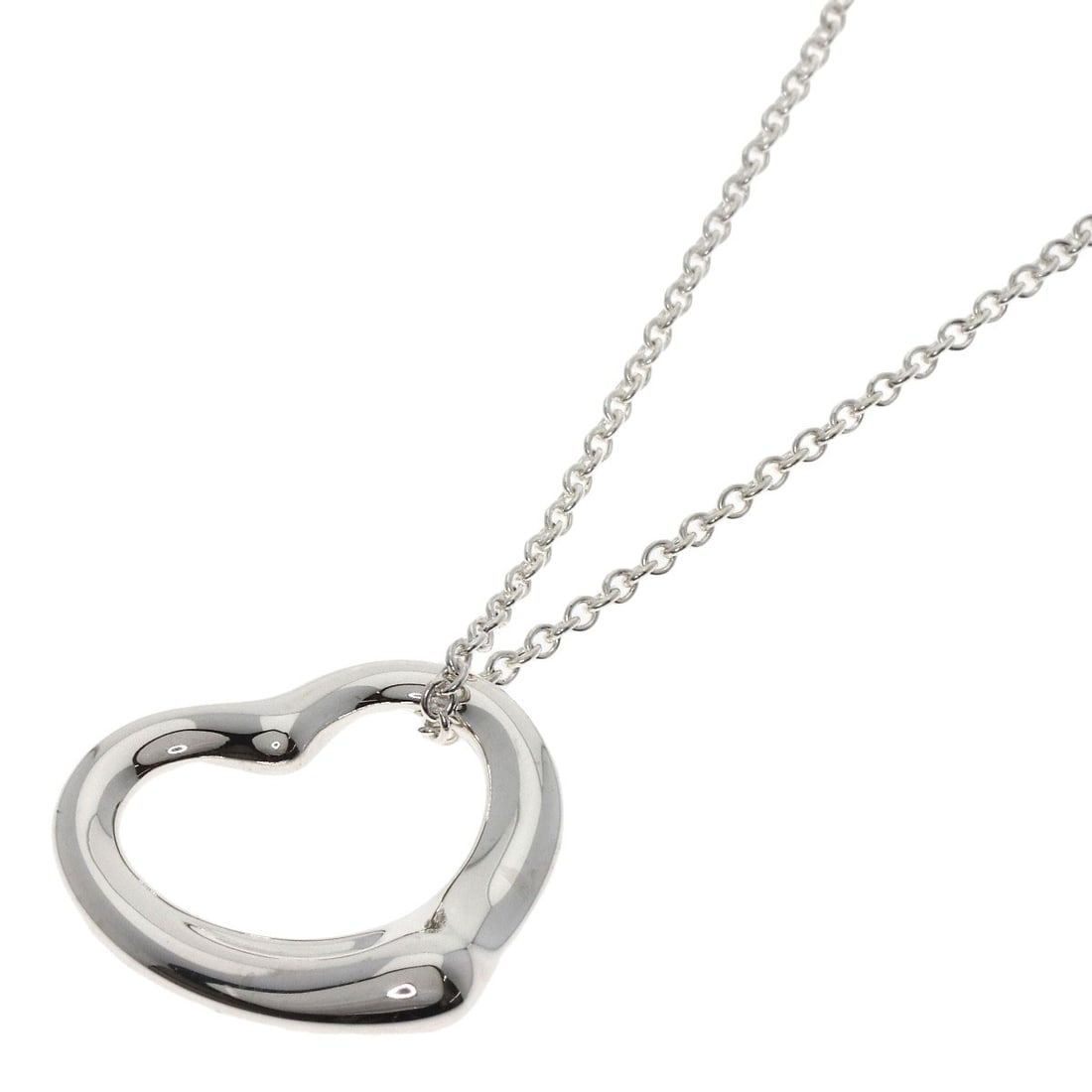 Open Heart Necklace by Tiffany & Co: Open Heart Necklace by Tiffany & Co The Open Heart Necklace by Tiffany & Co. is a sleek and modern design featuring a silver metal exterior. This 15.7-inch long necklace boasts a striking silver color