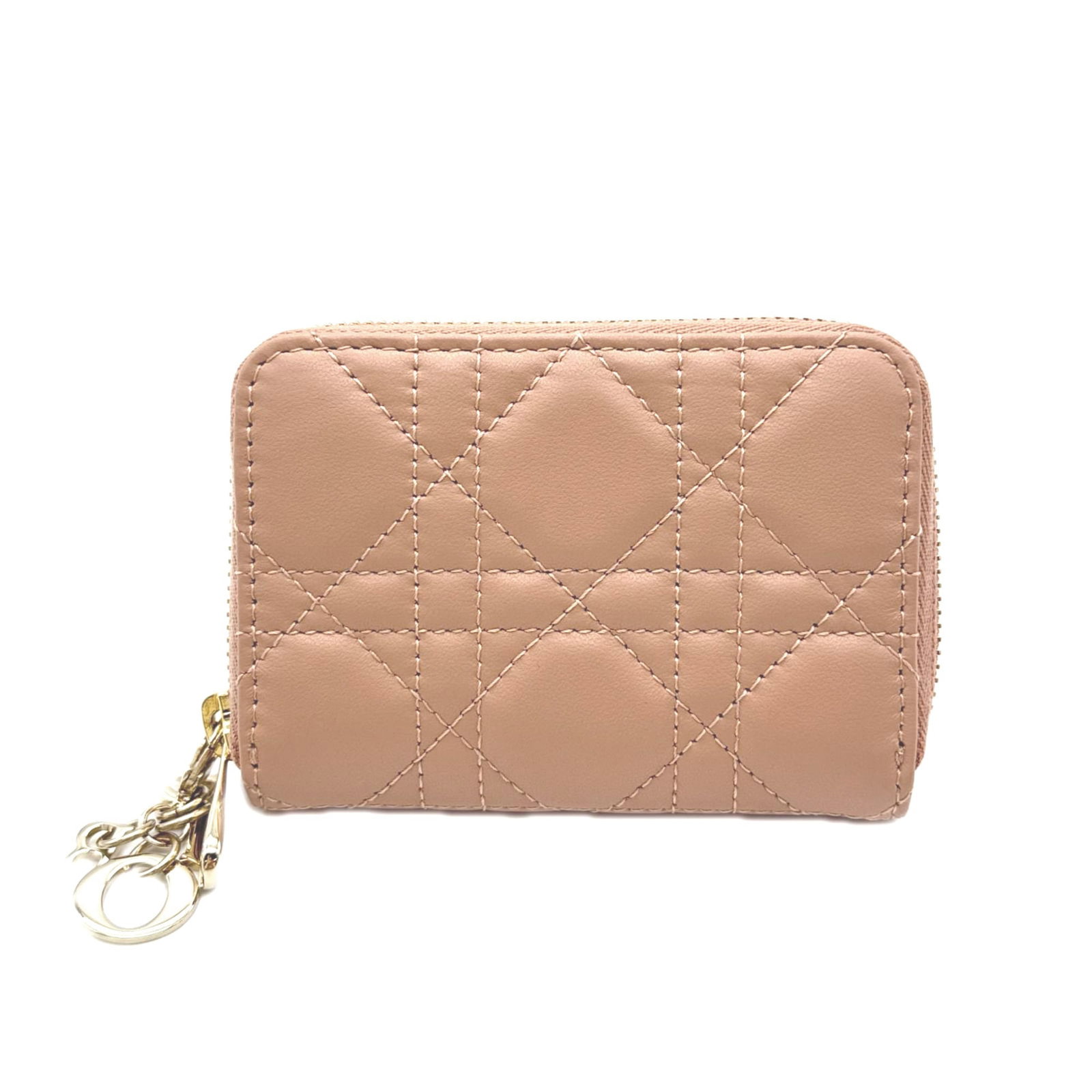 Dior Christian Coin Leather Purse: Dior Christian Coin Leather Purse The Dior Christian Coin Leather Purse is a stylish and compact accessory, featuring a lambskin exterior in a soft pink beige color. Its sleek design and zipper closur