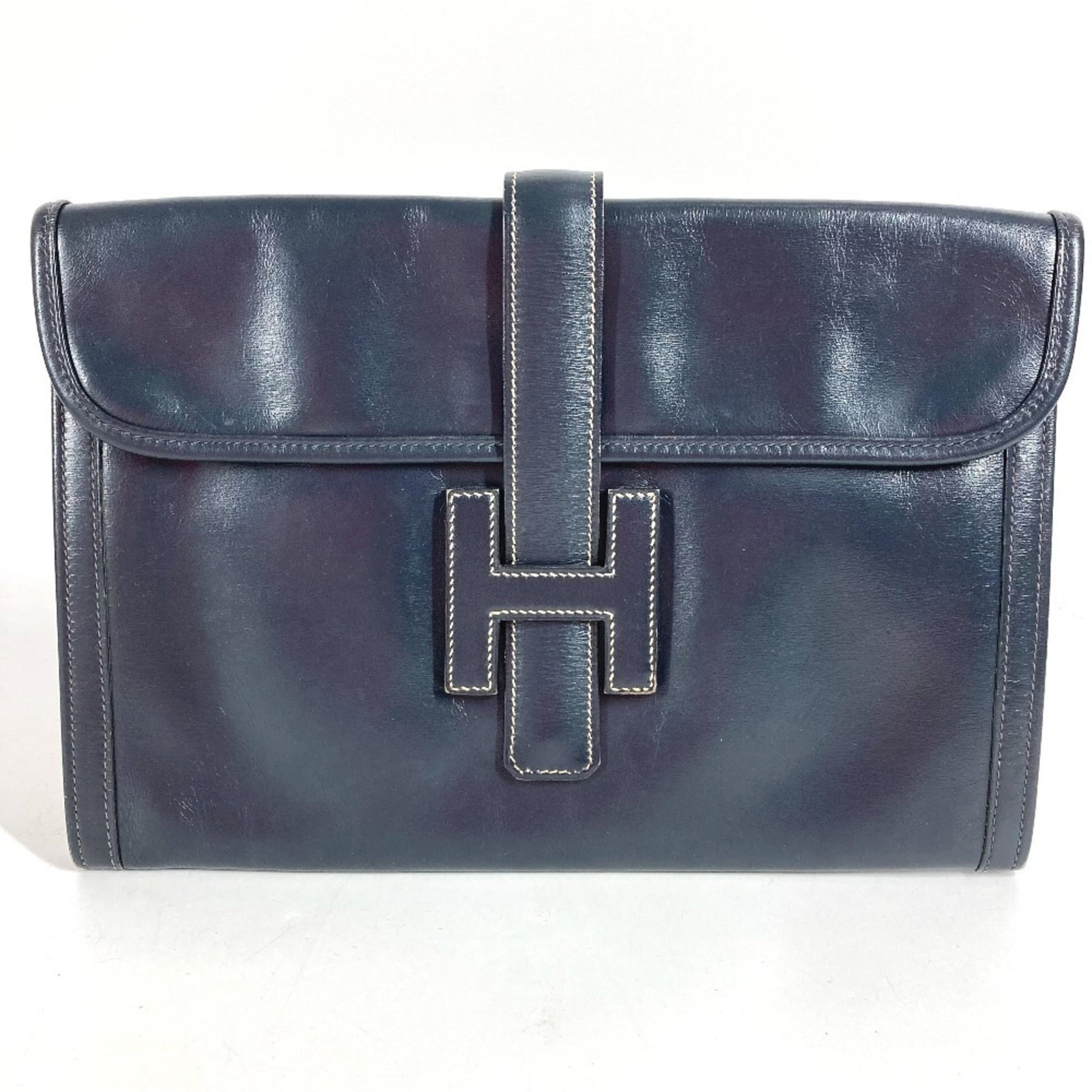 Calf Leather Bag Box Clutch Hermes: Calf Leather Bag Box Clutch Hermes Box calf leather construction and navy color make this Herm?s clutch a sophisticated accessory. Measuring 19cm x 28.5cm, it features a classic design with a sturdy