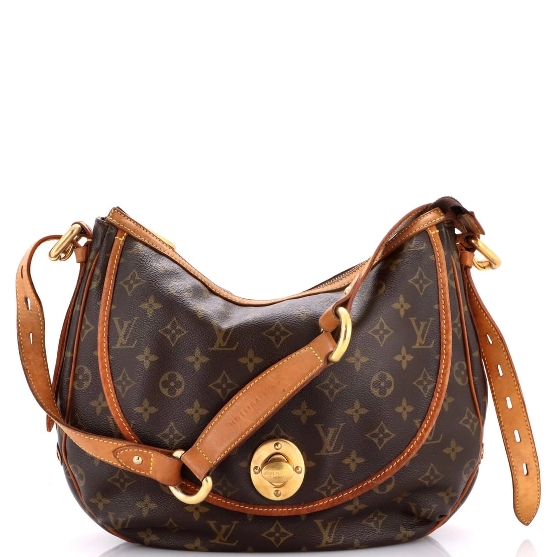 Handbag Louis Vuitton Tulum Monogram Canvas: Handbag Louis Vuitton Tulum Monogram Canvas Brown Louis Vuitton Tulum Monogram Canvas shoulder bag with heavy edge wear, corner wear, scuffs, creases, and minor cracking on the exterior. The interior 