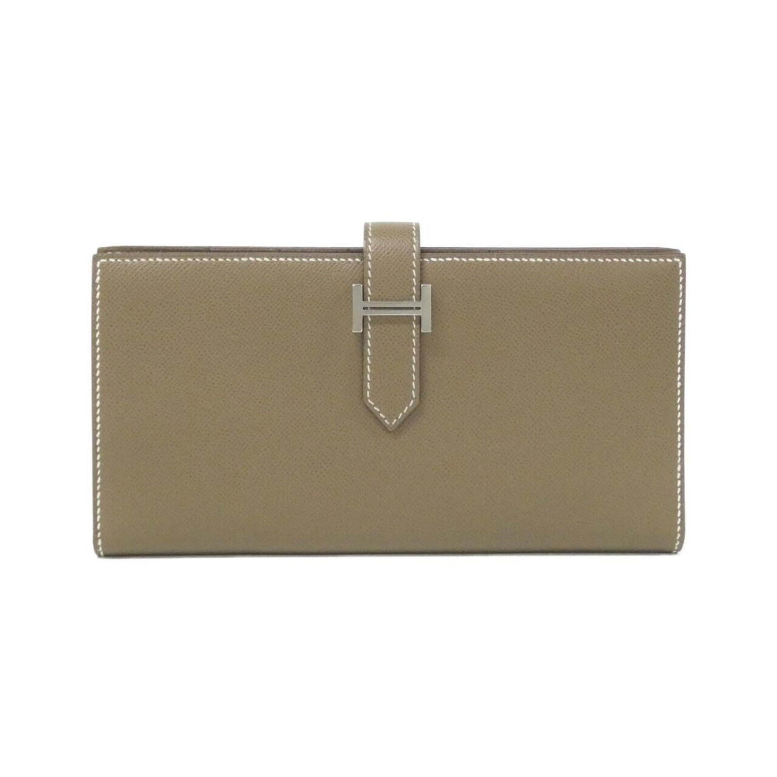 Hermes Long Wallet (Bi-Fold): Hermes Long Wallet (Bi-Fold) Etoupe gray and Soufre colors add a touch of sophistication to this bi-fold long wallet from Hermes. With its sleek design and slim profile, this wallet is perfect for