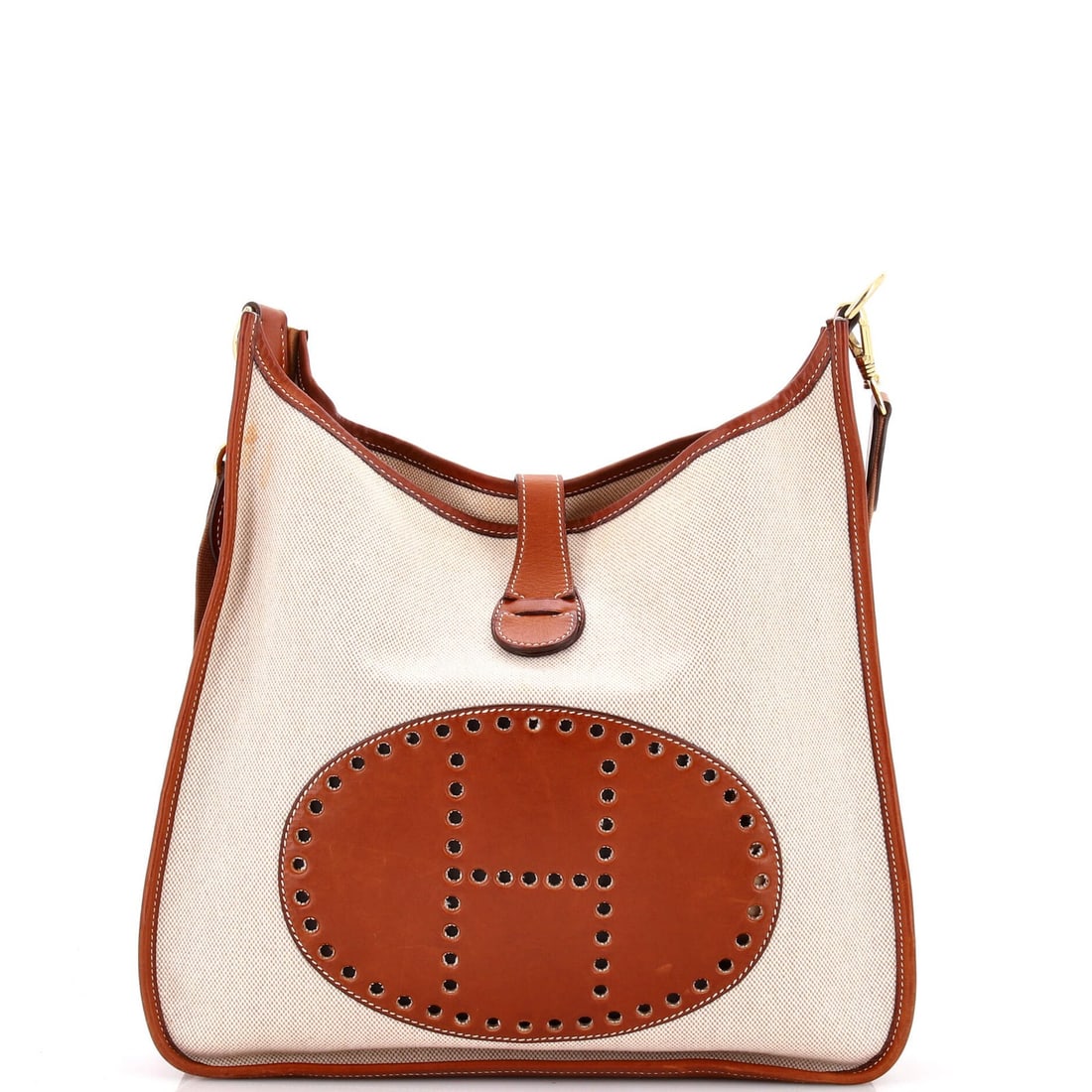 Hermes Evelyne Leather Bag Toile Gen I: Hermes Evelyne Leather Bag Toile Gen I The Hermes Evelyne Leather Bag Toile Gen I is a timeless, neutral-toned cross body bag with a classic design. Made from high-quality leather and canvas, this bag