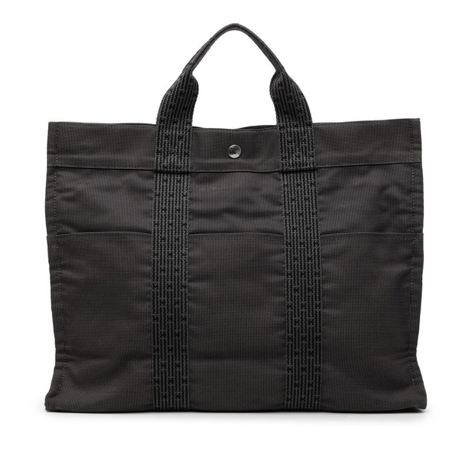 Canvas tote bag Hermes: Canvas tote bag Hermes Canvas tote bag from Hermes, featuring a sturdy canvas material and a gray color. Measuring 31cm x 42cm x 10cm, this bag is designed to carry essentials in style. The bag bears