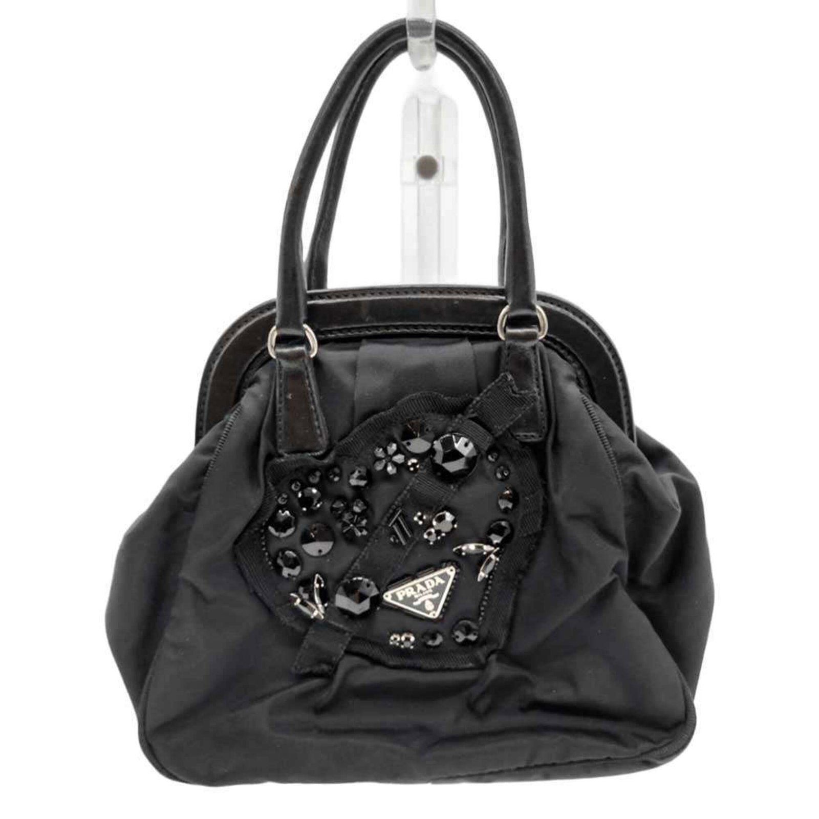 Nylon Prada Handbag: Nylon Prada Handbag Nylon Prada Handbag: A sleek and compact black handbag made from high-quality nylon, measuring 18.5cm x 20.5cm x 7.5cm. Bearing a signature, this stylish accessory is designed for