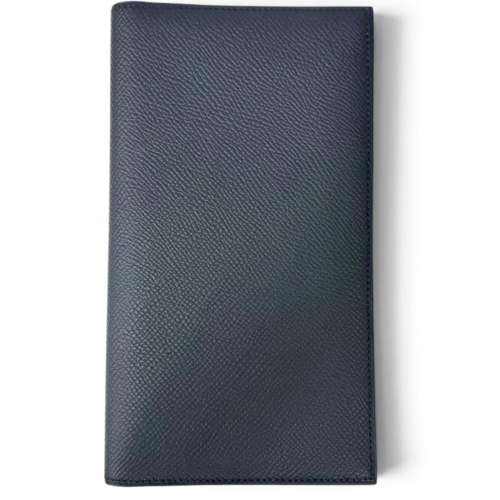Bi fold Epsom Leather Hermes Wallet: Bi fold Epsom Leather Hermes Wallet Epsom leather construction provides a luxurious feel to this bi-fold wallet from Hermes, with a classic navy color that exudes sophistication. The compact 17cm x 10