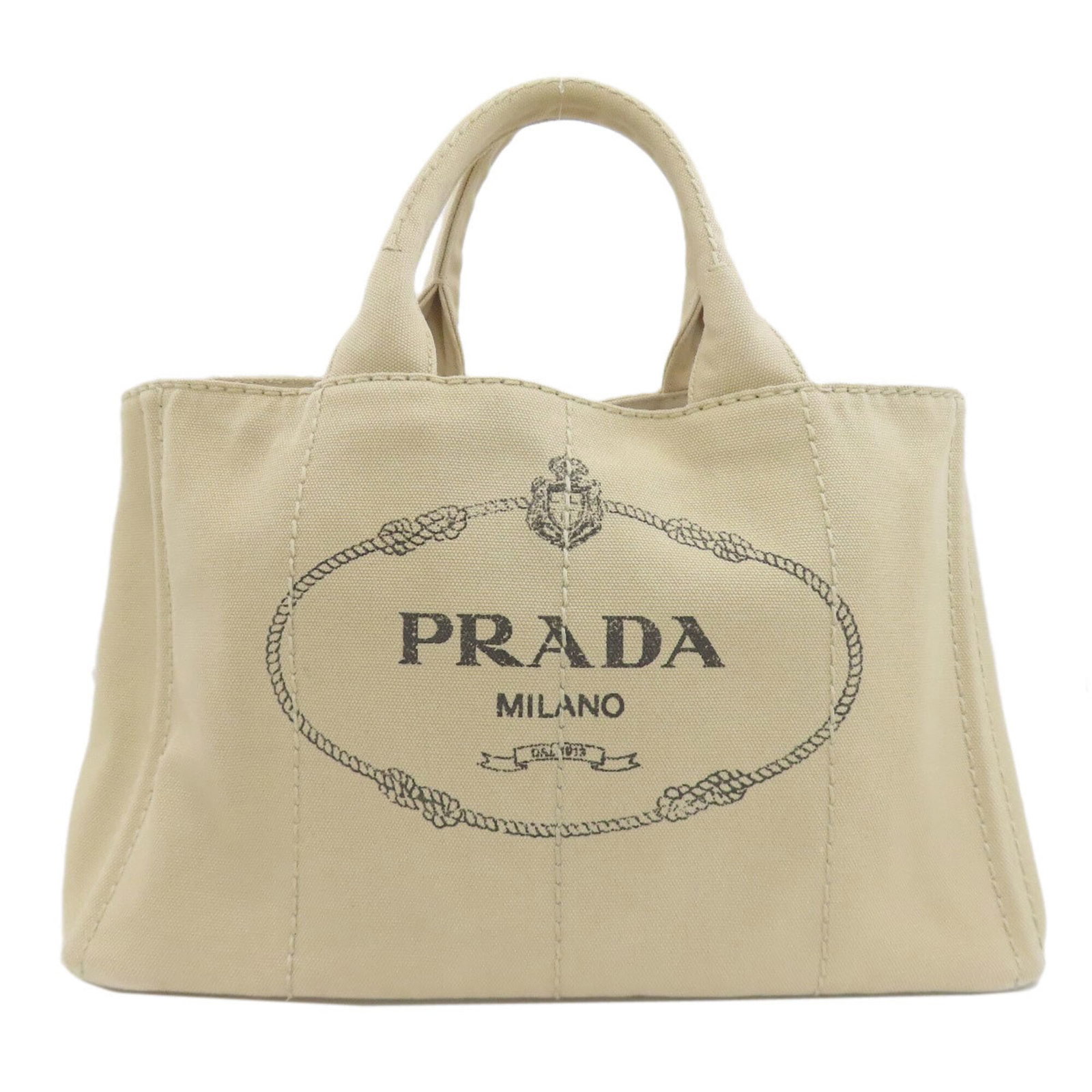 Handbag Canvas by Prada: Handbag Canvas by Prada Canvas by Prada is a beige women's handbag made from canvas, measuring 23cm x 35cm x 22cm. The bag bears a signature, and its canvas material provides a unique texture. This