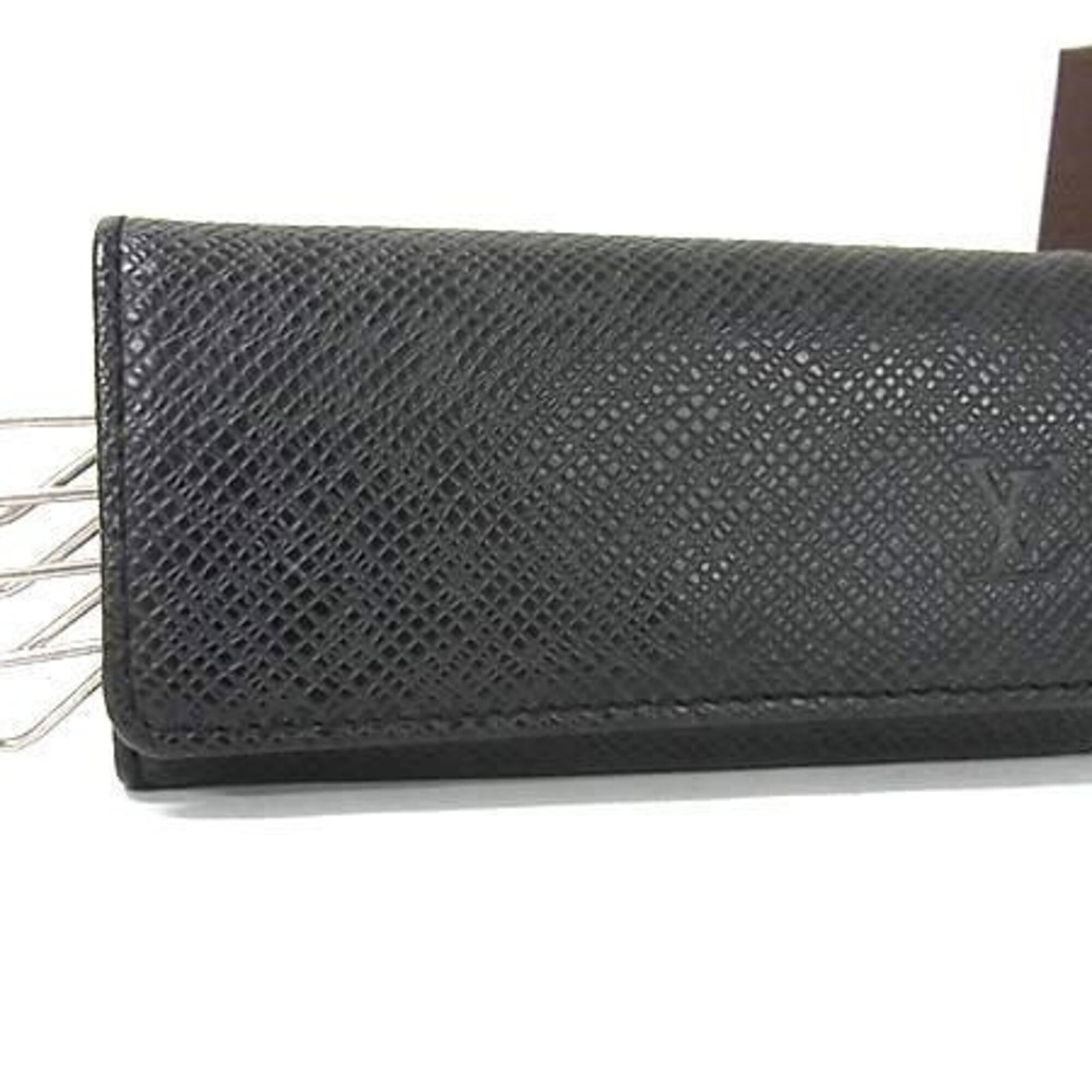 Taiga Leather Louis Vuitton Keycase: Taiga Leather Louis Vuitton Keycase Taiga Leather Louis Vuitton Keycase is crafted from high-quality Taiga leather, a distinctive material known for its unique texture and durability. This stylish