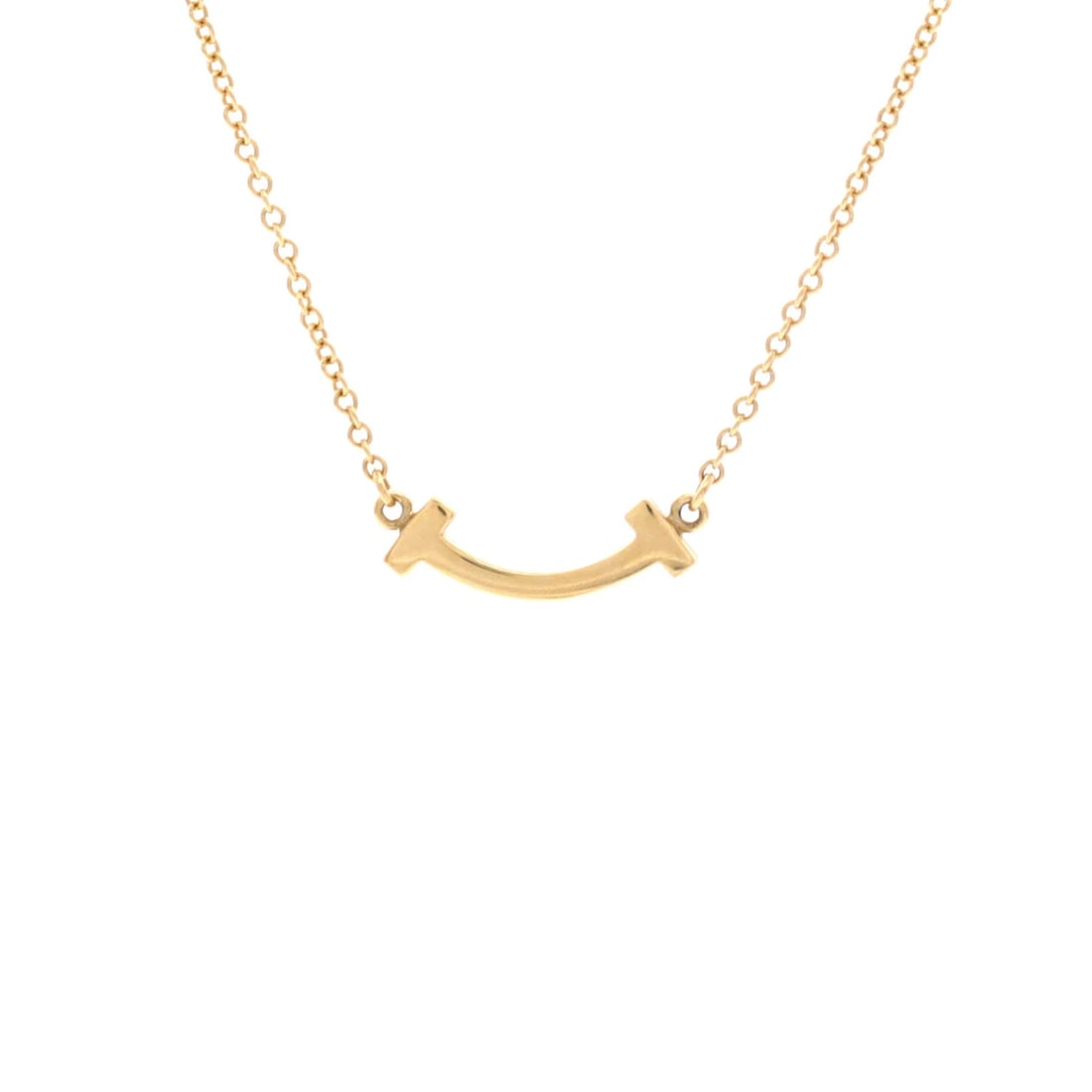 Tiffany & Co T Smile Pendant Necklace 18K Yellow Gold Mini: Tiffany & Co T Smile Pendant Necklace 18K Yellow Gold Mini 18K Yellow Gold Mini T Smile Pendant Necklace from Tiffany & Co. is a delicate 16.0-18.0" necklace featuring a 4.50mm x 14.05mm 18K Yellow