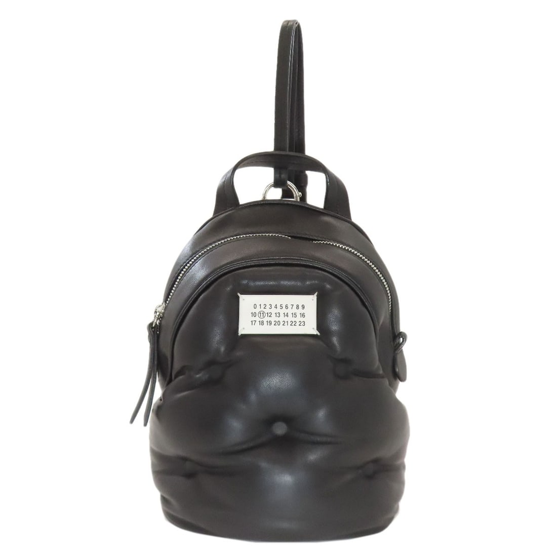 Maisonmargiela Logo Backpack Calf Daypack: Maisonmargiela Logo Backpack Calf Daypack Black Calf Leather Maison Margiela Logo Backpack. This A* Daypack features a black exterior with calf leather material, showcasing the brand's signature