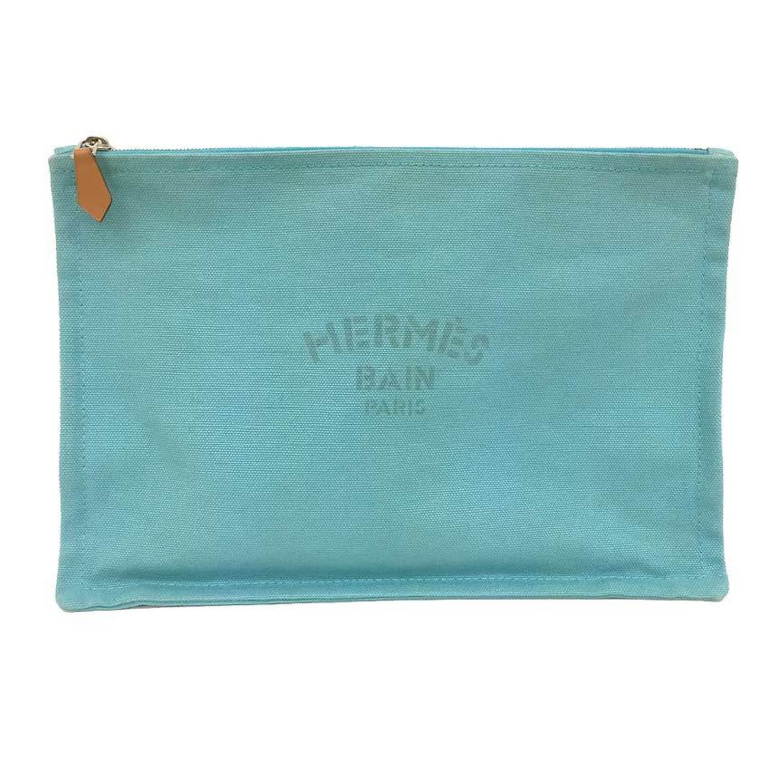 Pouch Canvas Hermes: Pouch Canvas Hermes Canvas pouch from the iconic brand Hermes, featuring a striking blue color and a size that fits perfectly at 18.5cm x 28cm. This canvas pouch is a straightforward accessory with