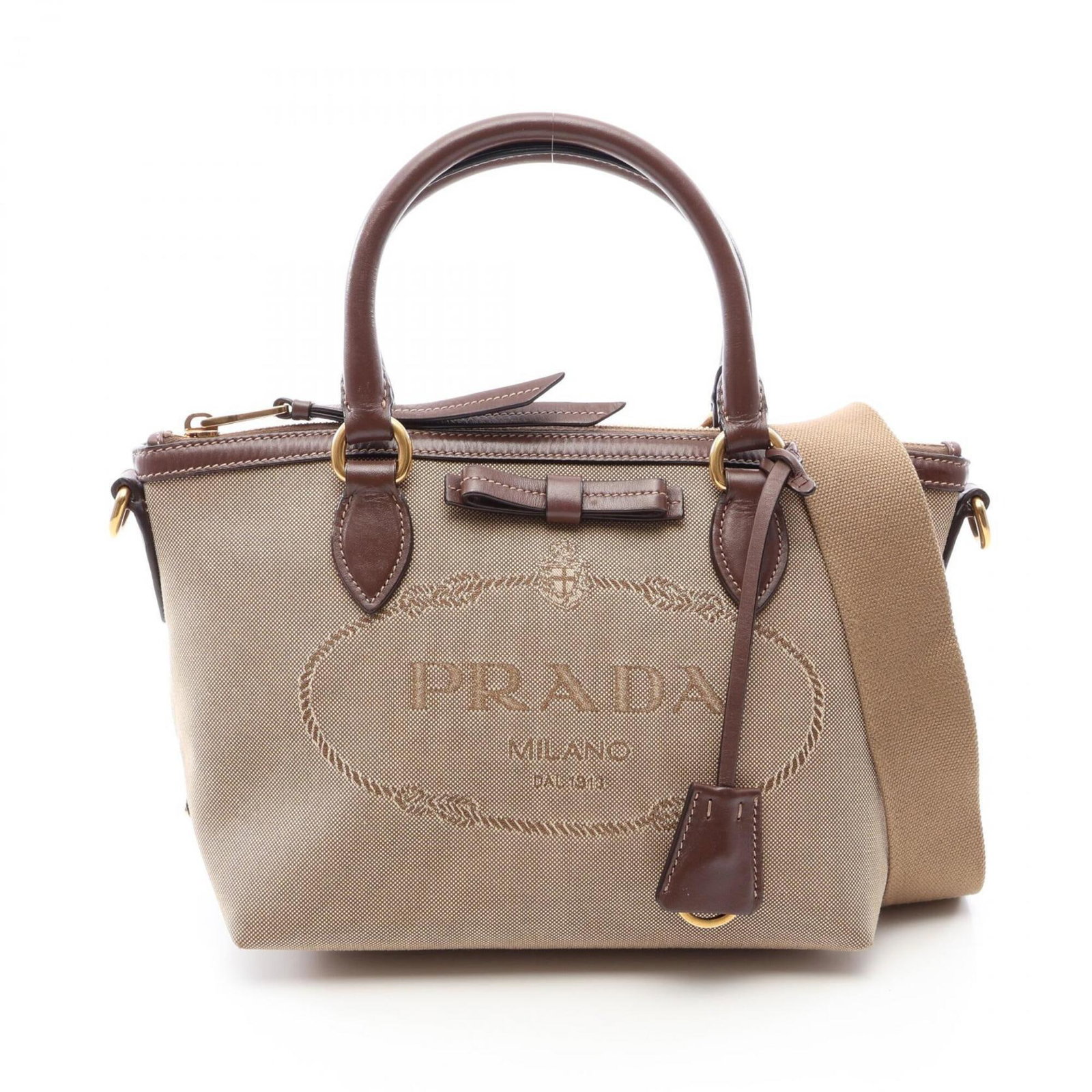Canvas Leather Handbag Prada: Canvas Leather Handbag Prada Canvas Leather Handbag Prada bears a signature, a notable feature of this item. Made from canvas and leather, this beige and brown handbag measures 19cm x 23cm x 13cm. Its