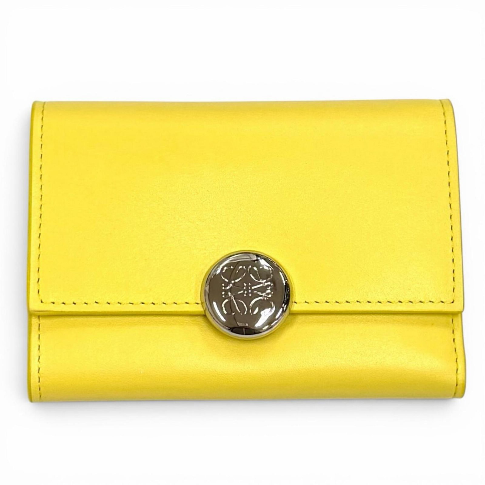 Loewe Wallet (Tri-Fold): Loewe Wallet (Tri-Fold) Tri-fold wallet from renowned Spanish luxury brand Loewe, featuring a sleek design with a signature touch. This stylish wallet measures 8.5cm x 11.6cm and boasts a classic