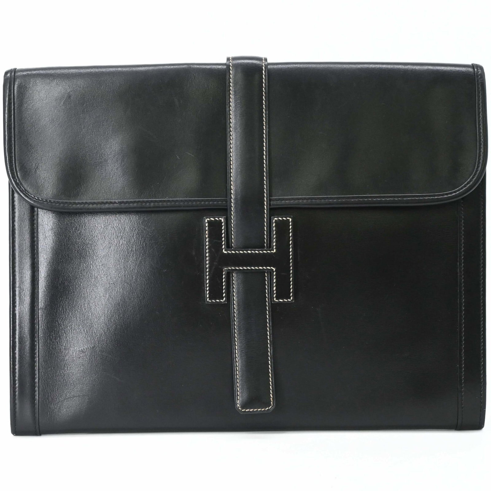 Calf Leather Bag Box Clutch Hermes: Calf Leather Bag Box Clutch Hermes Box calf leather construction provides a sturdy base for this sleek black clutch, measuring 26cm x 33.5cm x 2cm. The Jige line from Hermes is characterized by its