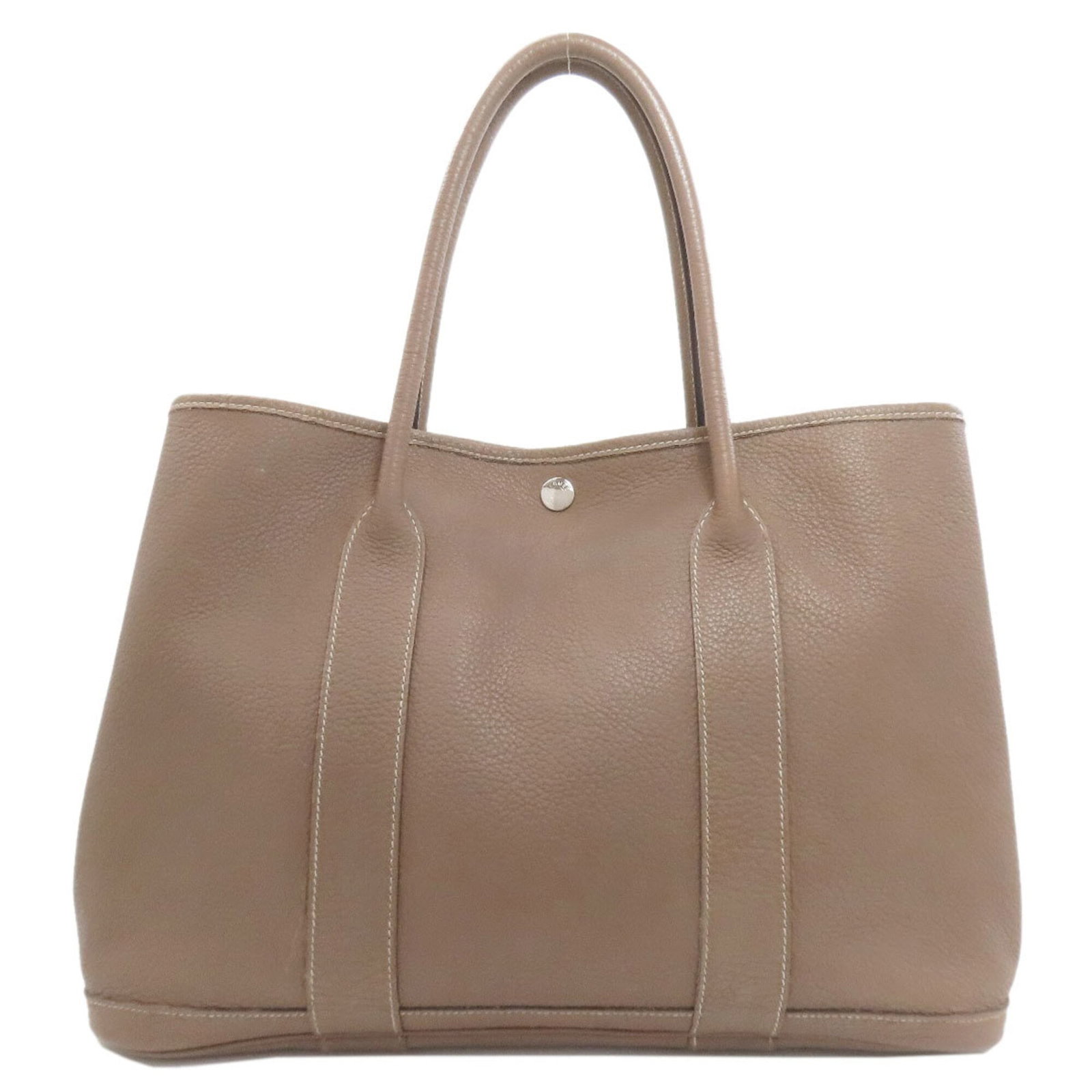 Hermes Negonda Leather Tote Bag: Hermes Negonda Leather Tote Bag Negonda leather tote bag from the iconic Hermes brand, featuring a timeless Etoupe gray color and classic design. Measuring 26cm x 36cm x 17cm, this bag is a versatile