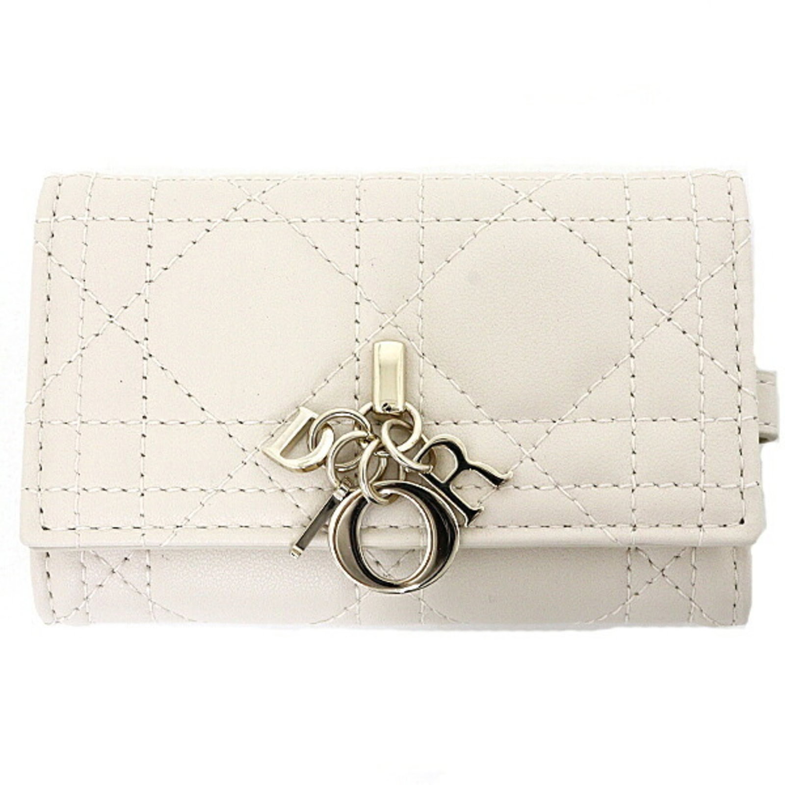 Keyring Stainless Steel Christian Dior: Keyring Stainless Steel Christian Dior Stainless steel keyring bearing the iconic Christian Dior logo, crafted in Japan with a sleek beige and pink design. The keyring's compact size and durable stain