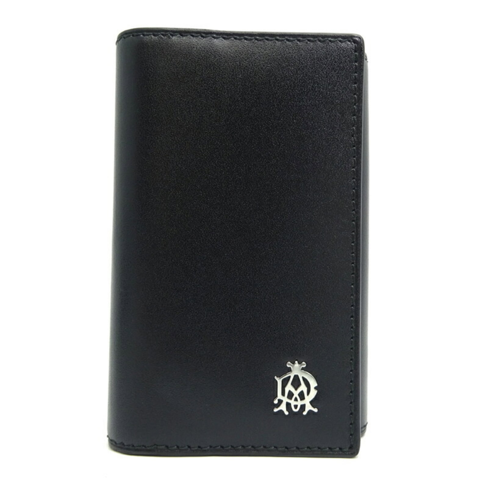 Keycase Leather by Dunhill: Keycase Leather by Dunhill Keycase Leather by Dunhill is a sleek black leather keycase with a button closure, perfectly sized for everyday use. The item comes with a box and shop card, providing a con