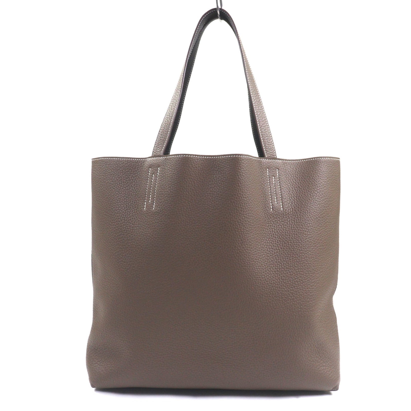 Tote bag clemence taurillon hermes leather: Tote bag clemence taurillon hermes leather Taurillon clemence leather tote bag from Hermes, crafted with Ebene and Etoupe gray tones, features an open closure and measures 34cm x 45cm x 11cm. This