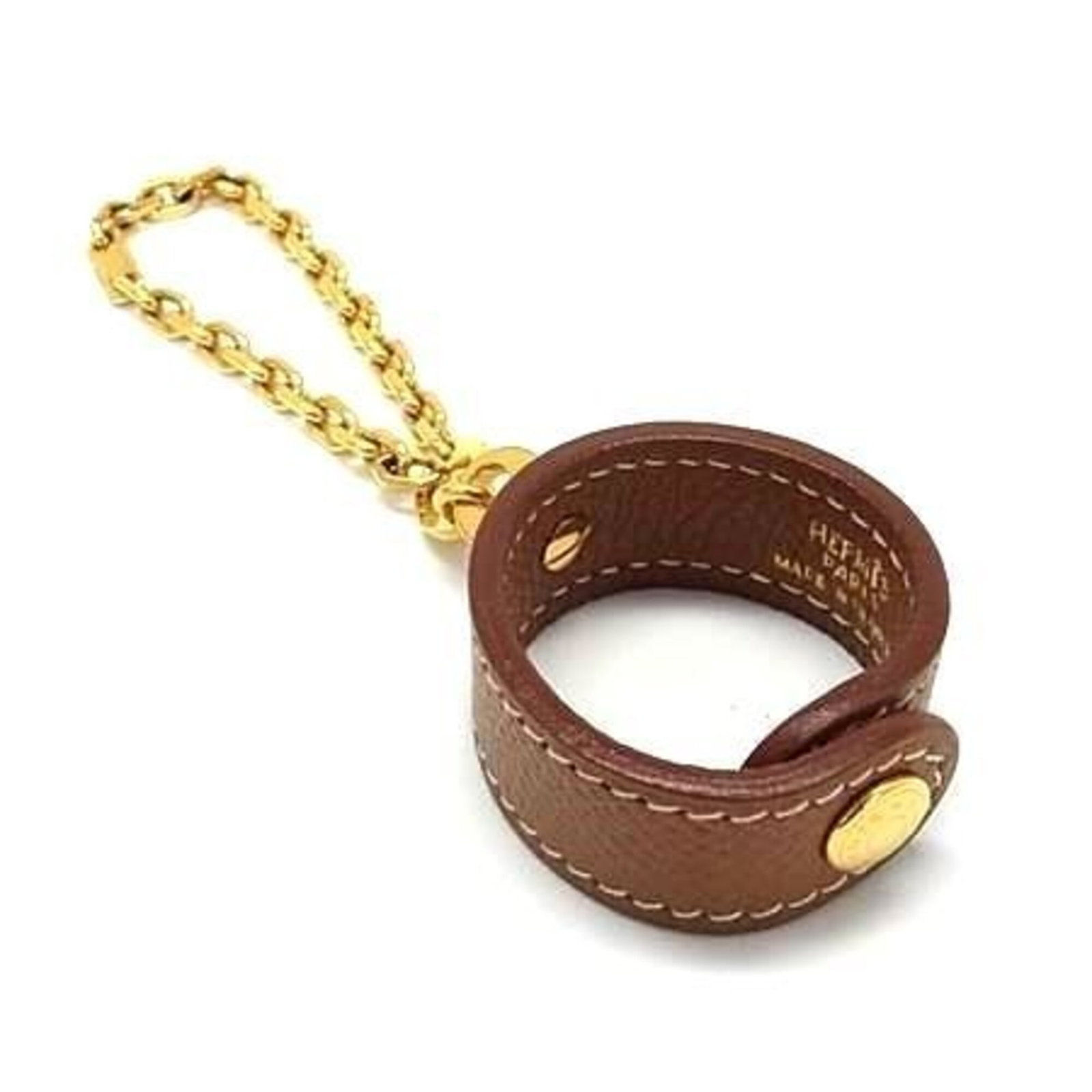 Hermes Glove Holder Leather: Hermes Glove Holder Leather Brown leather glove holder from Hermes, measuring 3.5cm x 3.5cm and 13.7cm in length, made from high-quality leather. This compact accessory is designed to keep gloves orga