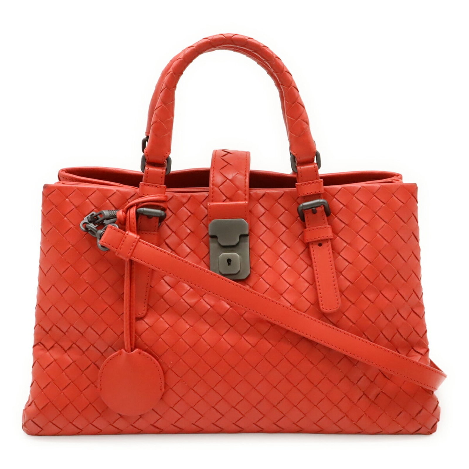 Veneta Leather Handbag: Veneta Leather Handbag The Veneta Leather Handbag boasts a striking red color and a unique Intrecciato design, showcasing Bottega Veneta's signature woven leather pattern. Measuring 20cm x 30.5cm x