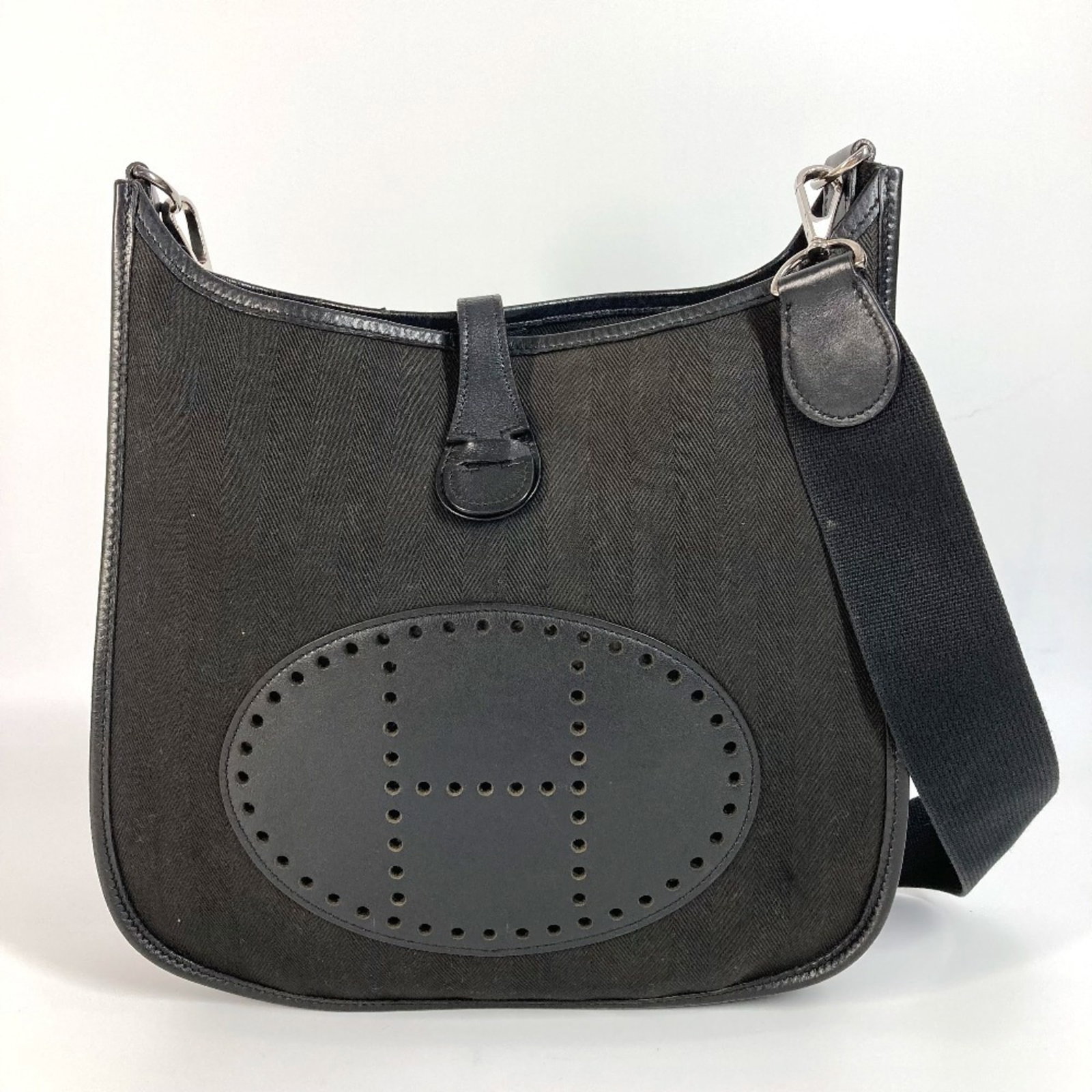 Leather Canvas Hermes Pochette Bag Shoulder: Leather Canvas Hermes Pochette Bag Shoulder Black Leather Canvas Pochette Bag from Hermes, measuring 27cm x 28.5cm x 7cm, offers a sleek and sophisticated design. This shoulder bag features a unique