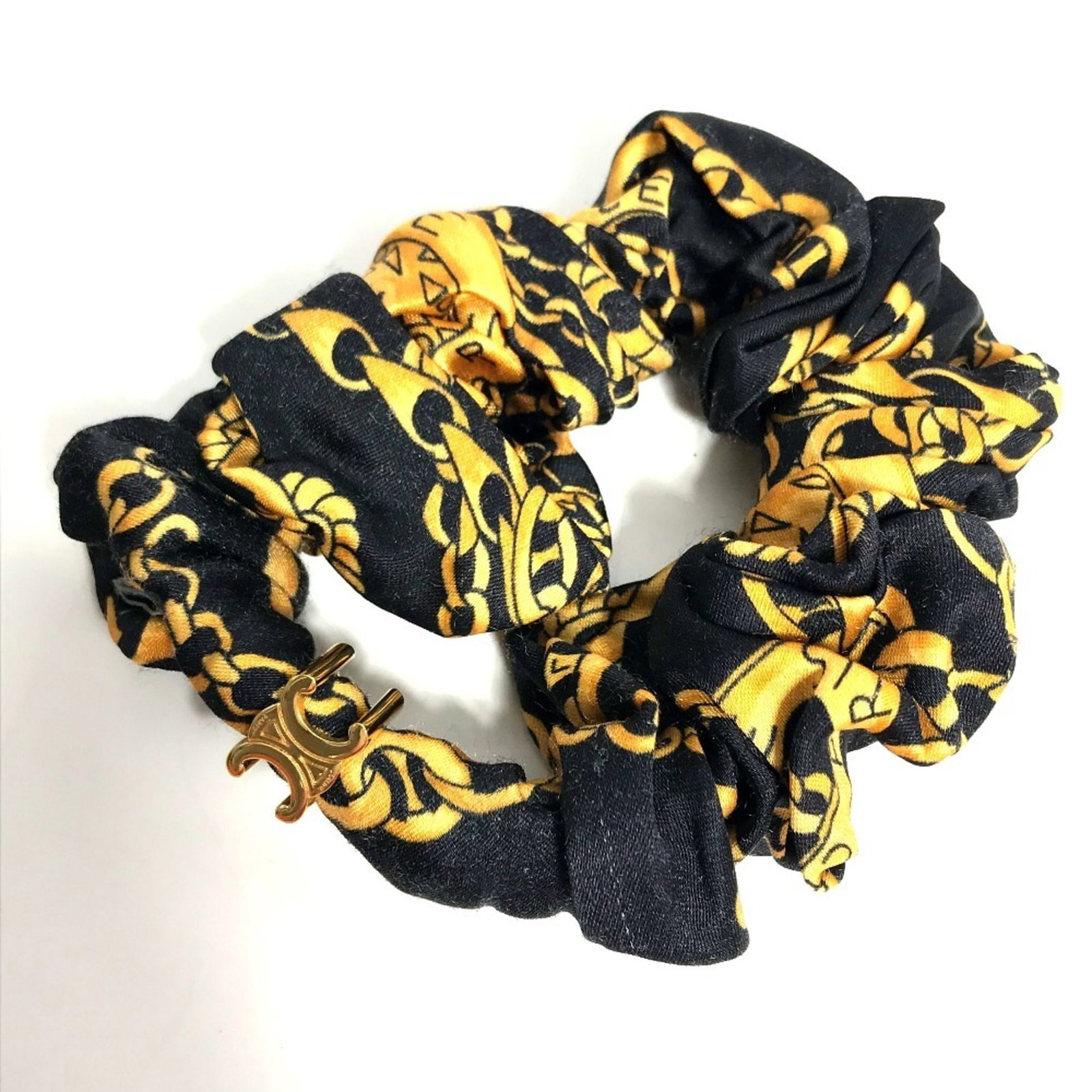 Silk Hair Tie Celine: Silk Hair Tie Celine Silk hair ties from Celine's collection come in a sleek black and vibrant yellow, adding a touch of elegance to any hairstyle. Made from luxurious silk, these hair ties are