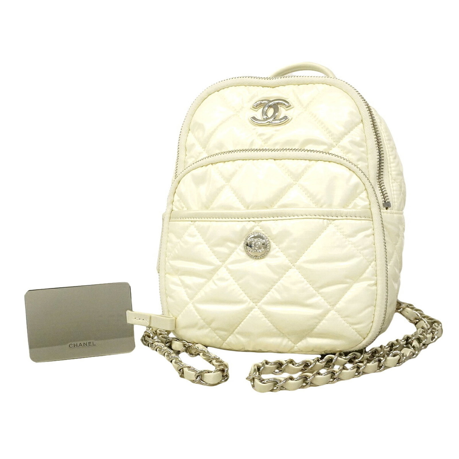 Nylon Backpack Chanel: Nylon Backpack Chanel The Chanel Nylon Backpack is a sleek and modern accessory, featuring a crisp white nylon exterior with silver hardware for a chic, high-end look. Measuring 22cm x 17.5cm x 9cm,