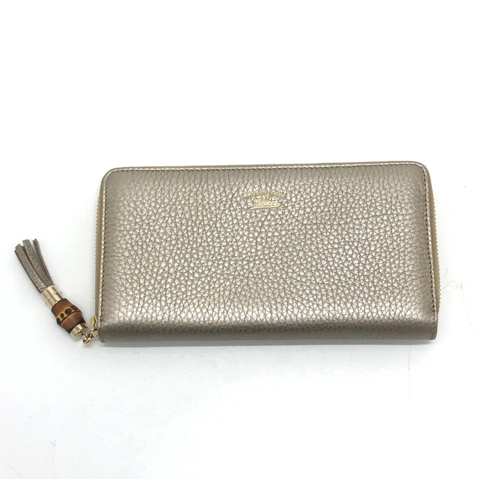 Gucci Long Wallet (Bi-Fold) Leather: Gucci Long Wallet (Bi-Fold) Leather Gucci's iconic bi-fold design makes a statement with its sleek, gold leather construction. The long wallet's classic proportions and refined details evoke a sense