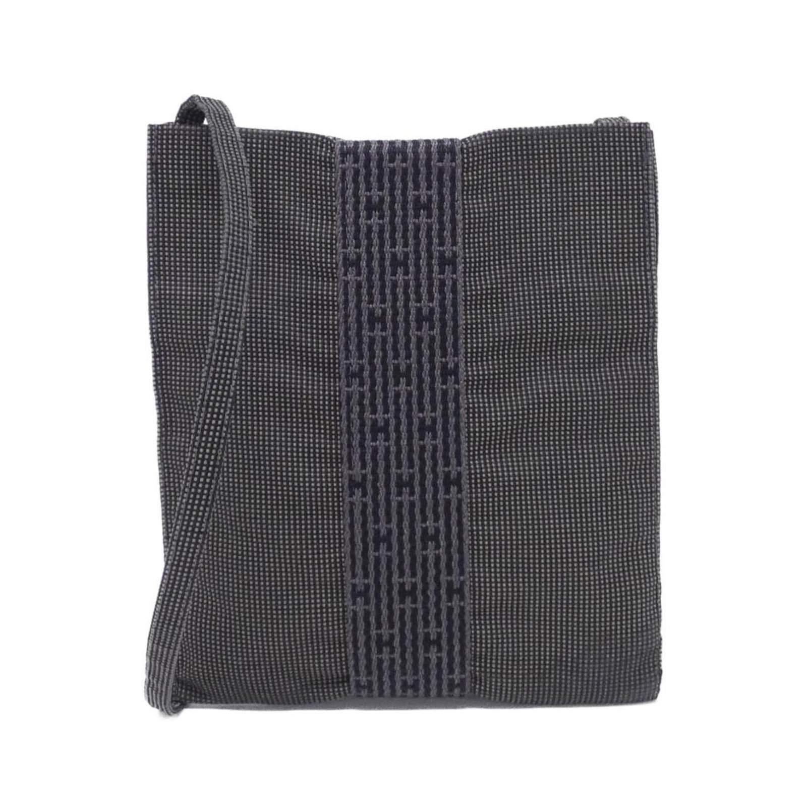 Shoulder Bag Canvas By Hermes: Shoulder Bag Canvas By Hermes Canvas By Hermes is a sleek and sophisticated shoulder bag, crafted from high-quality canvas material in a timeless black hue. Measuring 20cm x 17cm x 1cm, this