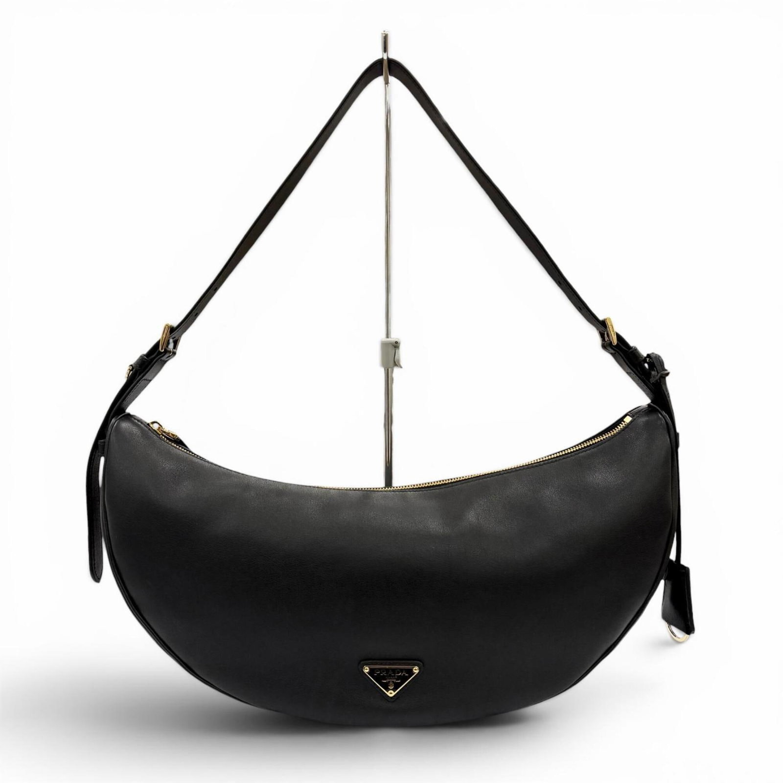 Shoulder Bag Leather Prada: Shoulder Bag Leather Prada Black Prada leather shoulder bag with dimensions 18.5cm x 42cm x 10cm, made from high-quality leather and bearing a signature. This stylish bag is a classic design from the 