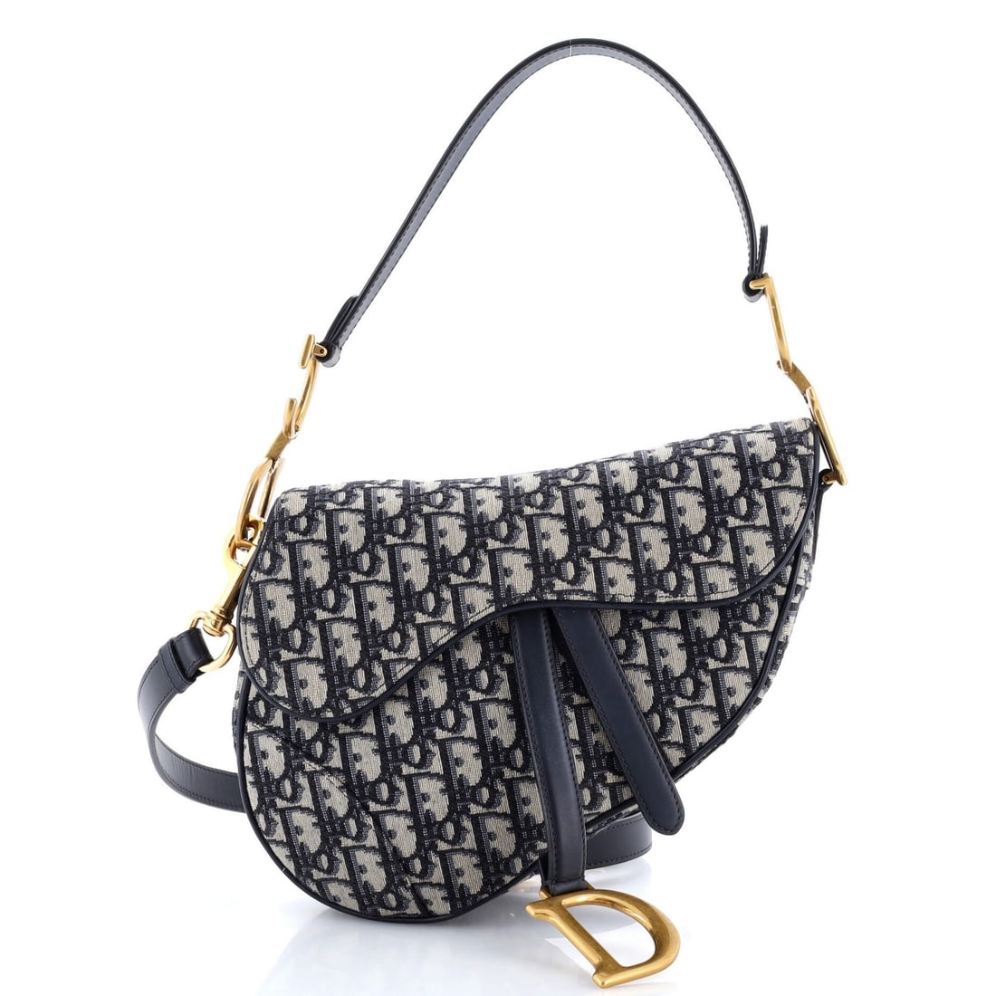 Saddle Handbag Strap Oblique Canvas Medium Christian Dior: Saddle Handbag Strap Oblique Canvas Medium Christian Dior Saddle Handbag with Strap Oblique Canvas Medium from Christian Dior features a striking blue canvas exterior with oblique design, showcasing t