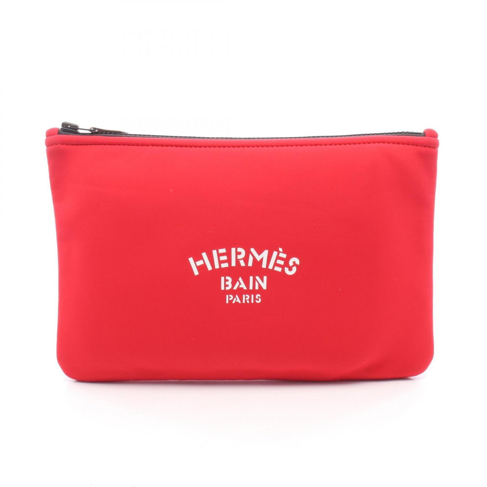 Handbag Pouch Neoprene by Hermes: Handbag Pouch Neoprene by Hermes The Handbag Pouch Neoprene by Hermes is a striking red neoprene pouch, measuring 20cm x 28cm. Its unique material and bold color make it a distinctive accessory. The p