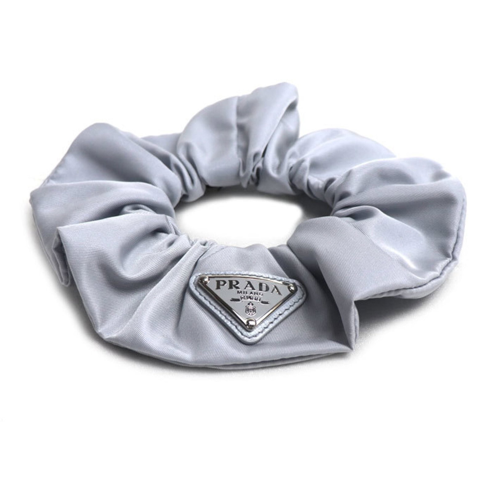 Scrunchie Nylon by Prada: Scrunchie Nylon by Prada Scrunchie in gray nylon from Prada, made in Italy. This 14cm x 4.5cm scrunchie features a simple yet elegant design. Item Specifics: Brand: Prada Country of Origin: Italy MPN: