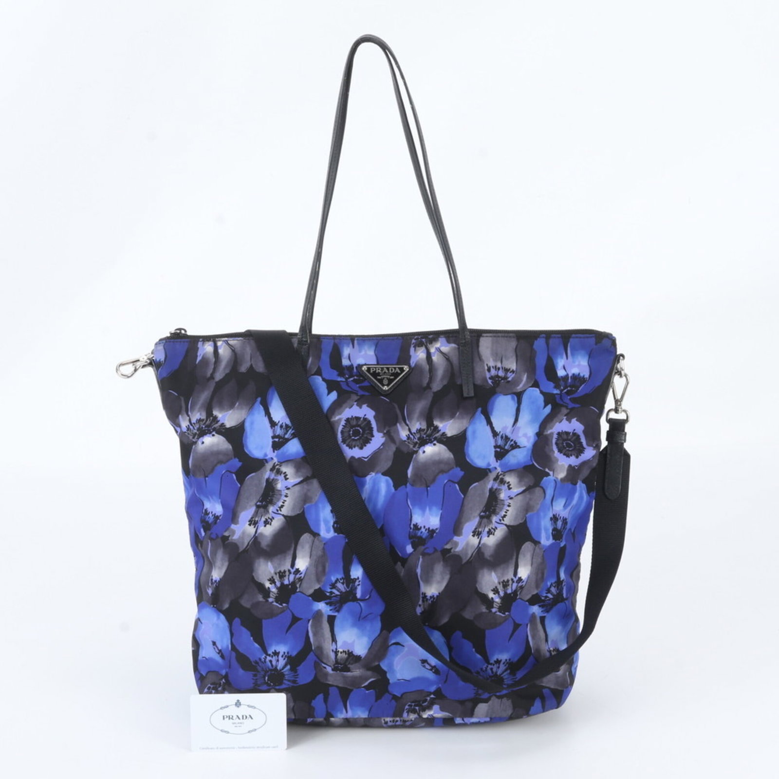 Nylon Leather Tote Prada Shoulder Bag: Nylon Leather Tote Prada Shoulder Bag Nylon and leather combine in this sleek Prada shoulder bag, available in black and blue. Measuring 30cm x 32cm x 14cm, it features a sturdy design with a