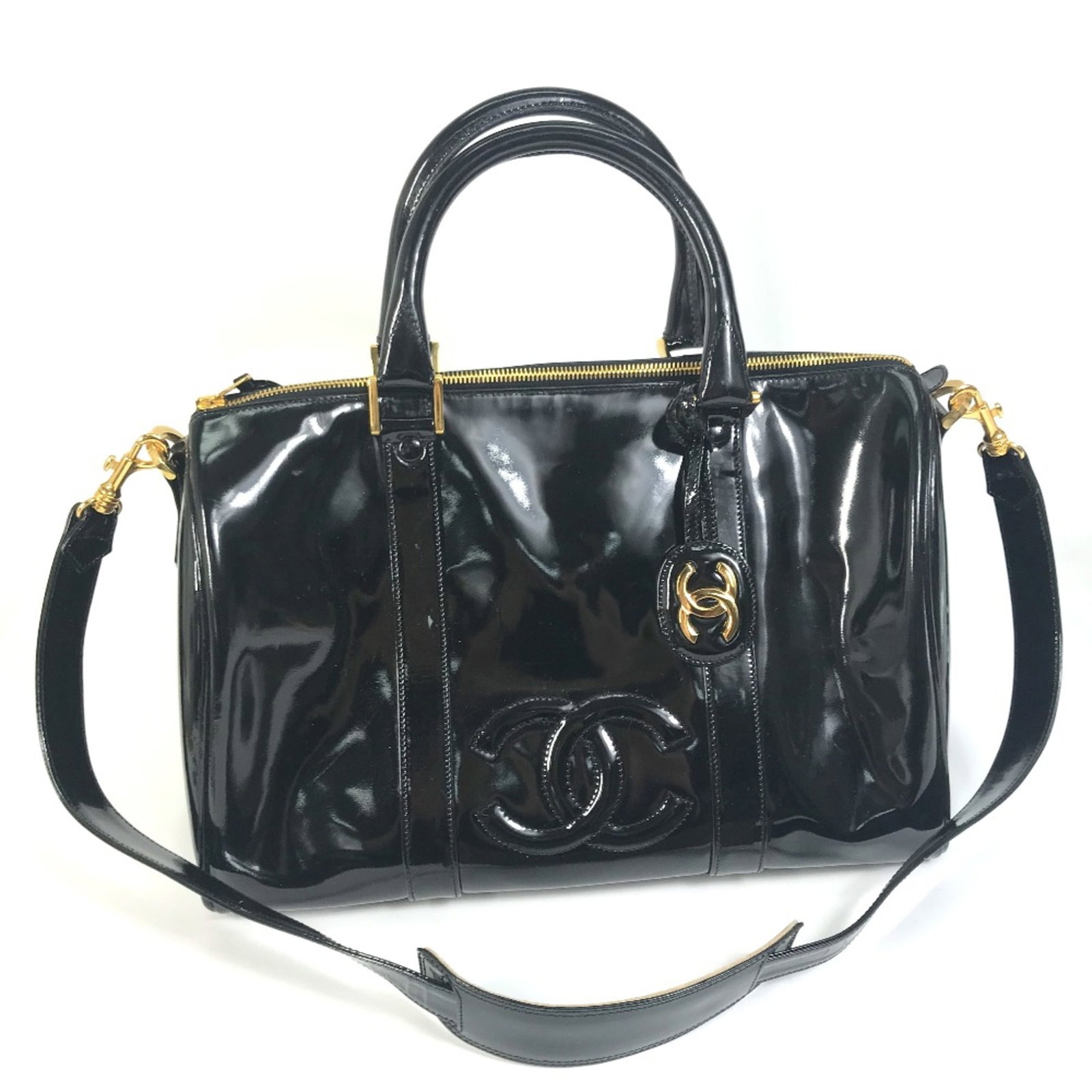 Patent Leather Bag Boston Chanel: Patent Leather Bag Boston Chanel Patent leather exterior, classic Boston bag design, and signature Chanel logo make this black bag a timeless piece. Measuring 35cm x 21cm x 16cm, it features a sleek a