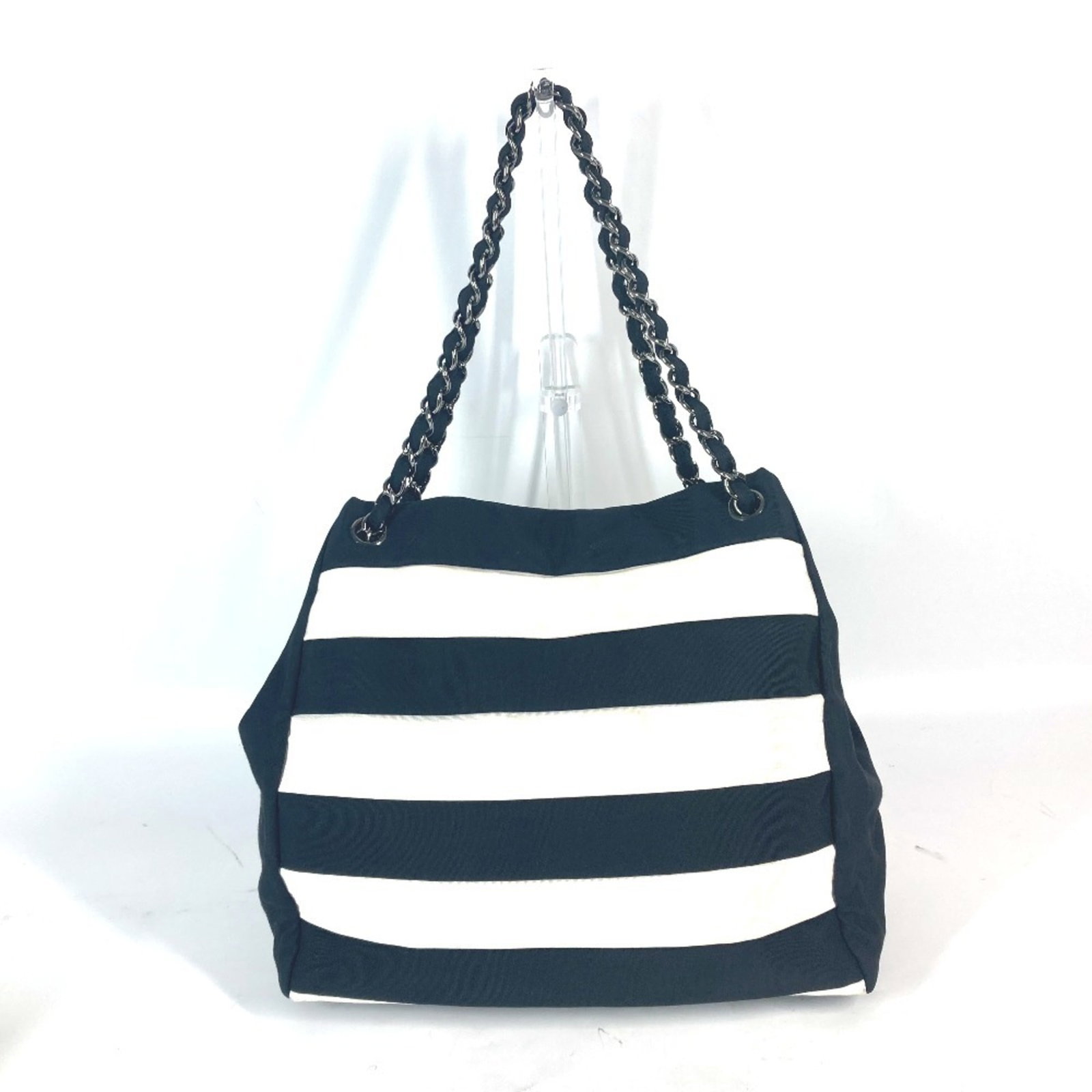 Shoulder Bag Nylon Canvas by Chanel: Shoulder Bag Nylon Canvas by Chanel Black or White Nylon Canvas Shoulder Bag by Chanel, 28cm x 24.5cm x 12cm. Made from nylon canvas, this shoulder bag features a classic design with clean lines and