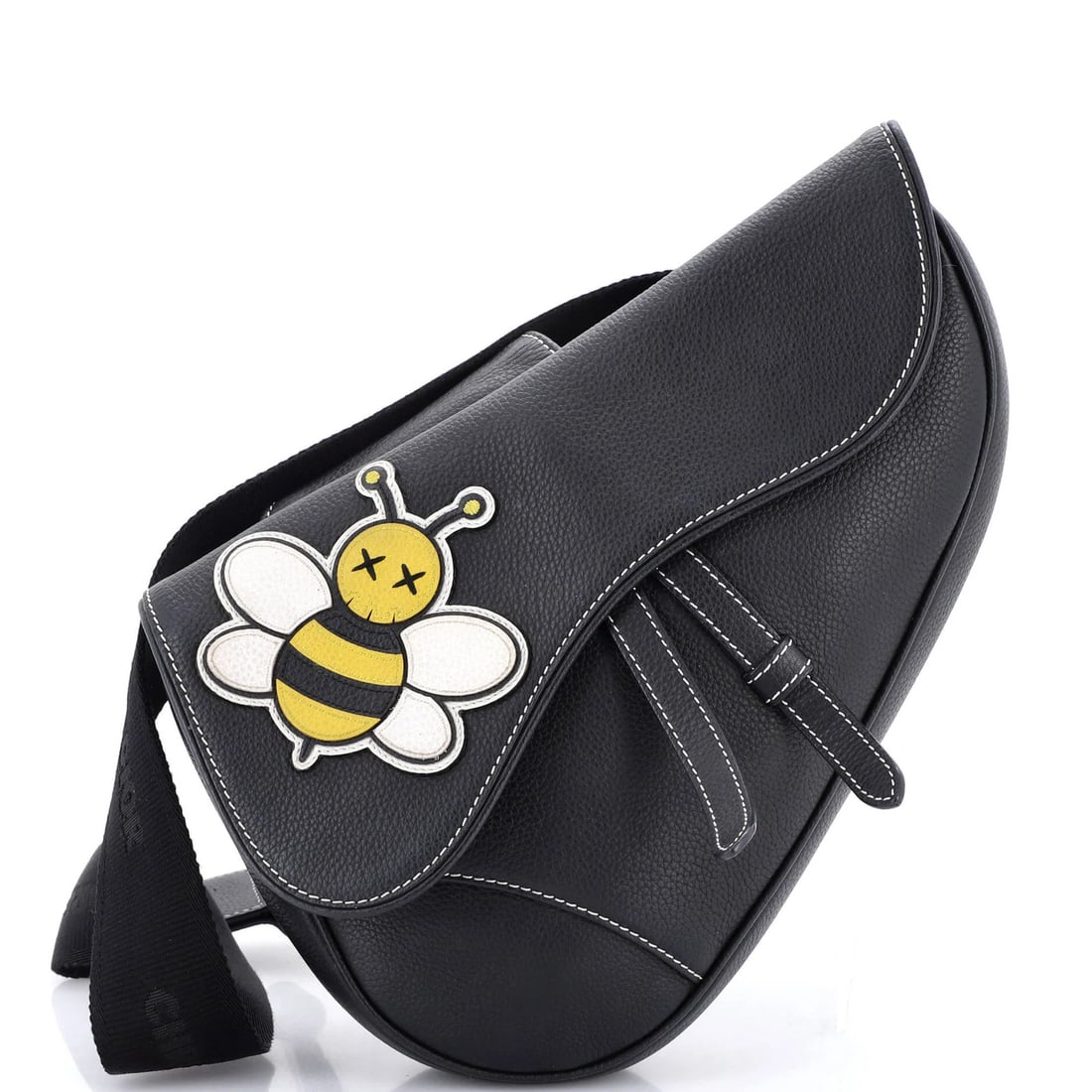 Saddle Crossbody Bag Leather with Christian Dior KAWS Applique: Saddle Crossbody Bag Leather with Christian Dior KAWS Applique The Christian Dior KAWS Saddle Crossbody Bag Leather features a striking black leather exterior adorned with a bold applique, adding a