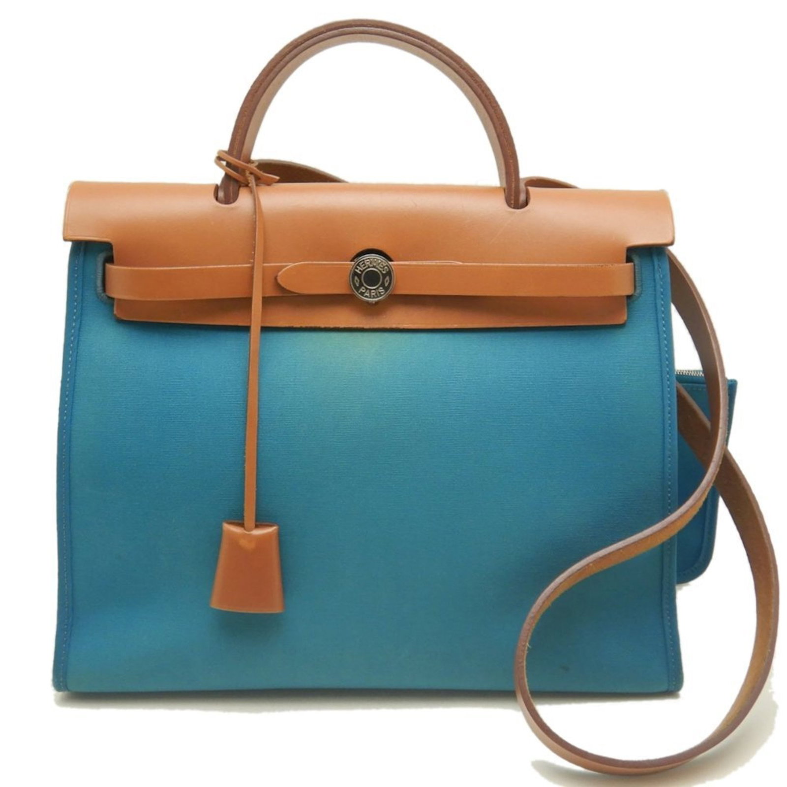 Handbag Hermes Toile Officier Leather: Handbag Hermes Toile Officier Leather Turquoise blue Toile Officier leather wraps around the body of this stunning Hermes handbag, adorned with silver hardware and a sleek belt closure. The bag's