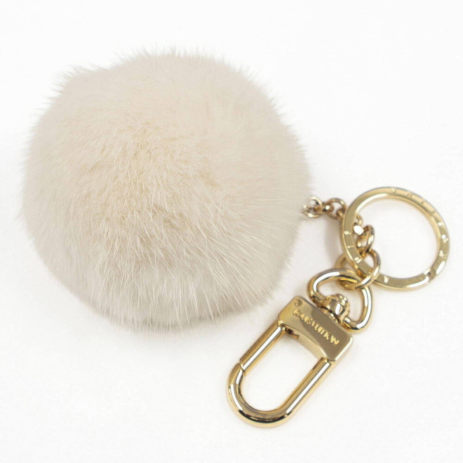 Keyring Fur Metal Louis Vuitton: Keyring Fur Metal Louis Vuitton Gold and ivory Louis Vuitton keyring features a luxurious mink fur charm, complemented by metal accents, making it a stylish accessory for everyday carry. The keyring m