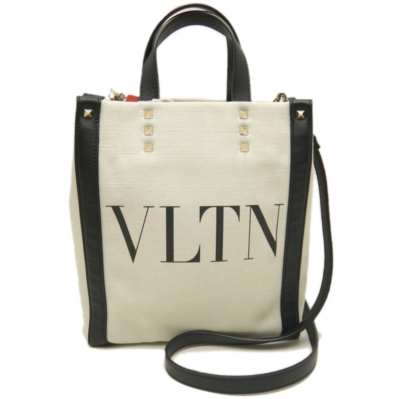 Canvas tote bag by Valentino Garavani: Canvas tote bag by Valentino Garavani Canvas tote bag by Valentino Garavani, crafted from high-quality canvas and leather, features a sleek black and white design. Measuring 23cm x 21cm x 8cm, this