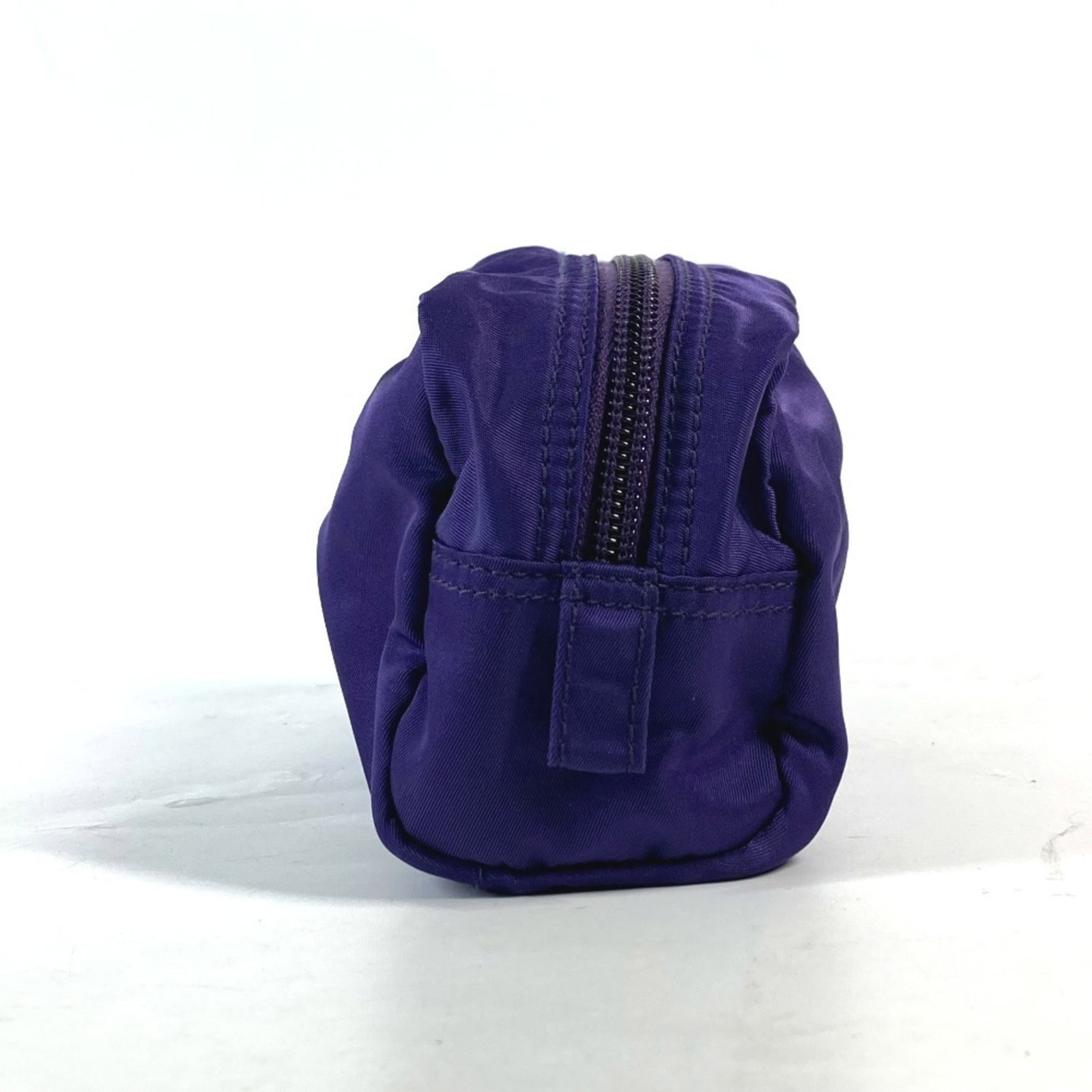 Nylon Prada Pouch: Nylon Prada Pouch Nylon Prada Pouch in Purple. This 1NA350 model pouch features a sleek design made from high-quality nylon material and measures 8.5cm x 18cm. The vibrant purple color adds a pop of s