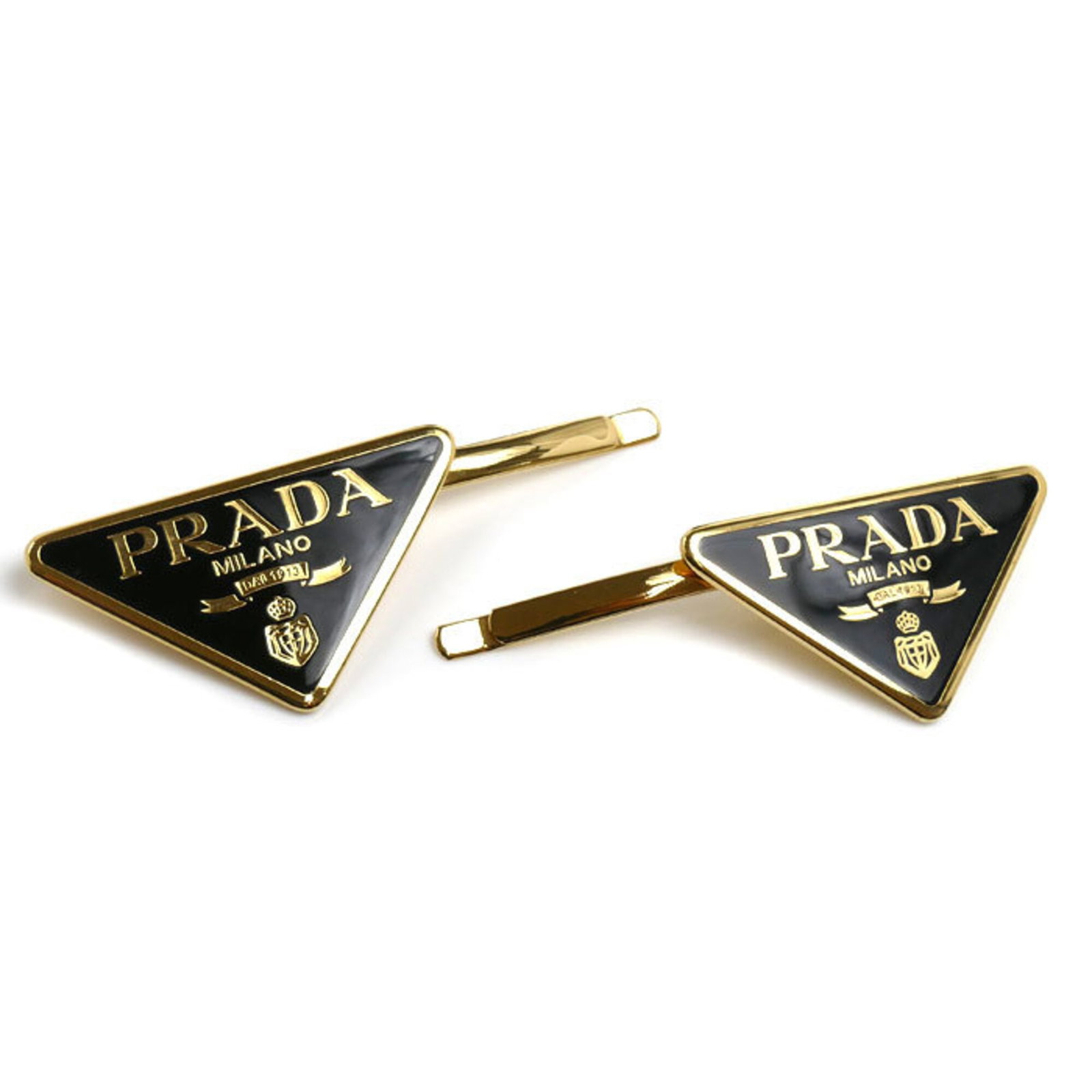 Hair Pin Brass Prada: Hair Pin Brass Prada Brass Hair Pin by Prada, Italy, measures 2.48cm x 4.5cm, featuring a sleek black and gold design. Made from high-quality brass, this hair pin is a stylish accessory for women.