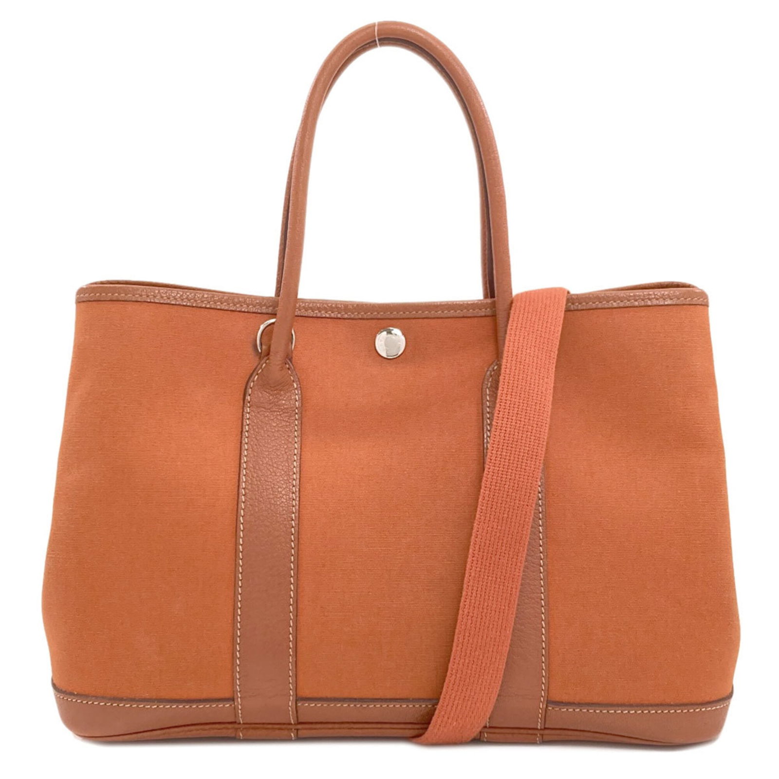 Handbag Hermes Leather Canvas: Handbag Hermes Leather Canvas Canvas and Negonda leather come together in this unique handbag from Hermes, boasting a distinctive brown and orange color combination. Measuring 21cm x 30cm x 14cm, it o